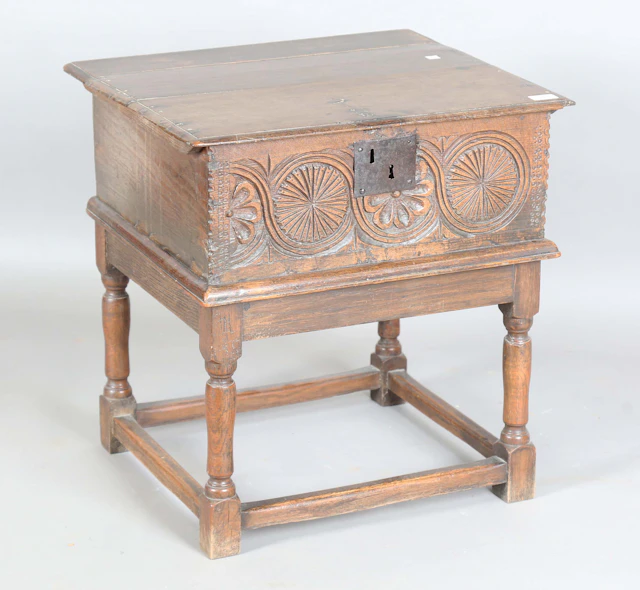 A late 17th/early 18th century oak bible box, the front carved with