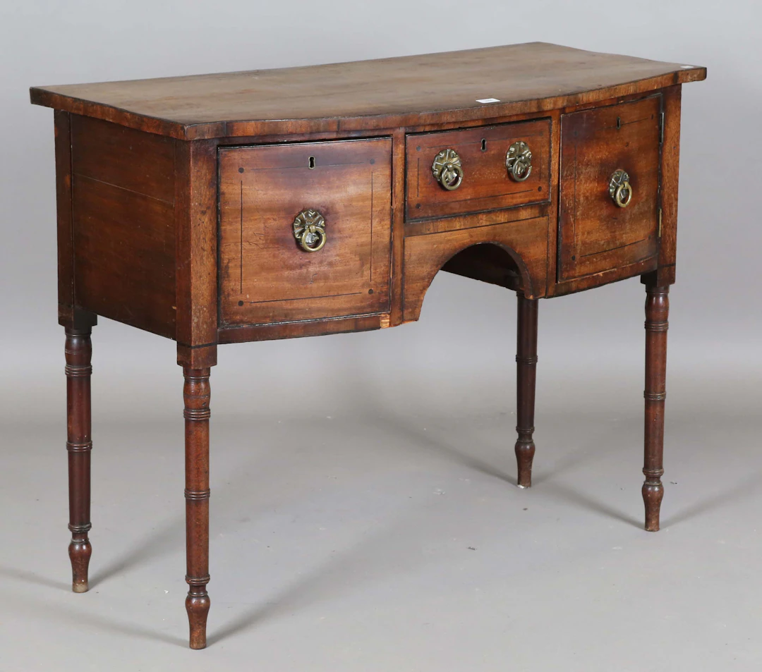 A Regency mahogany bowfront sideboard with ebony line inlay and pressed
