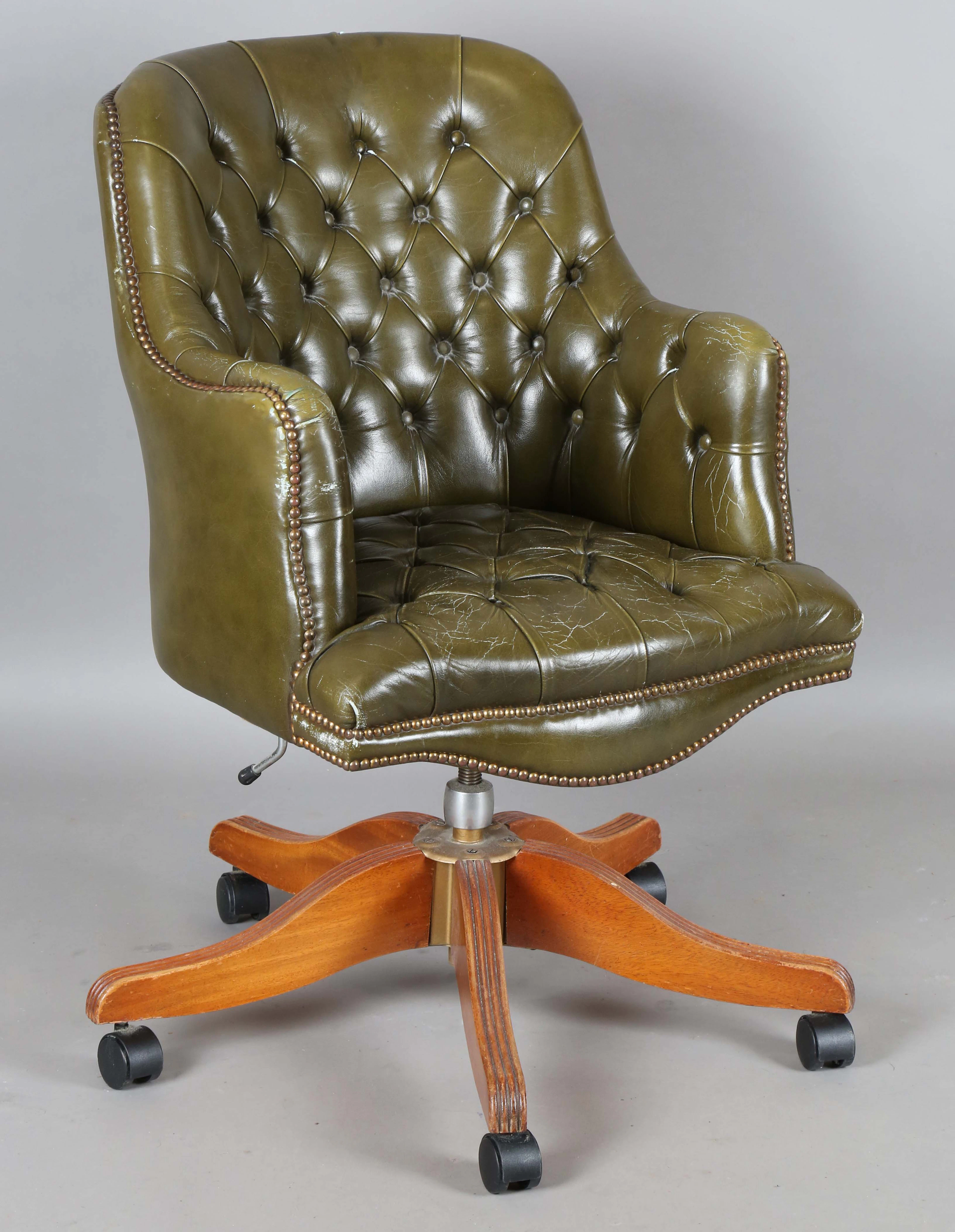 A late 20th century green studded leather tub back revolving desk