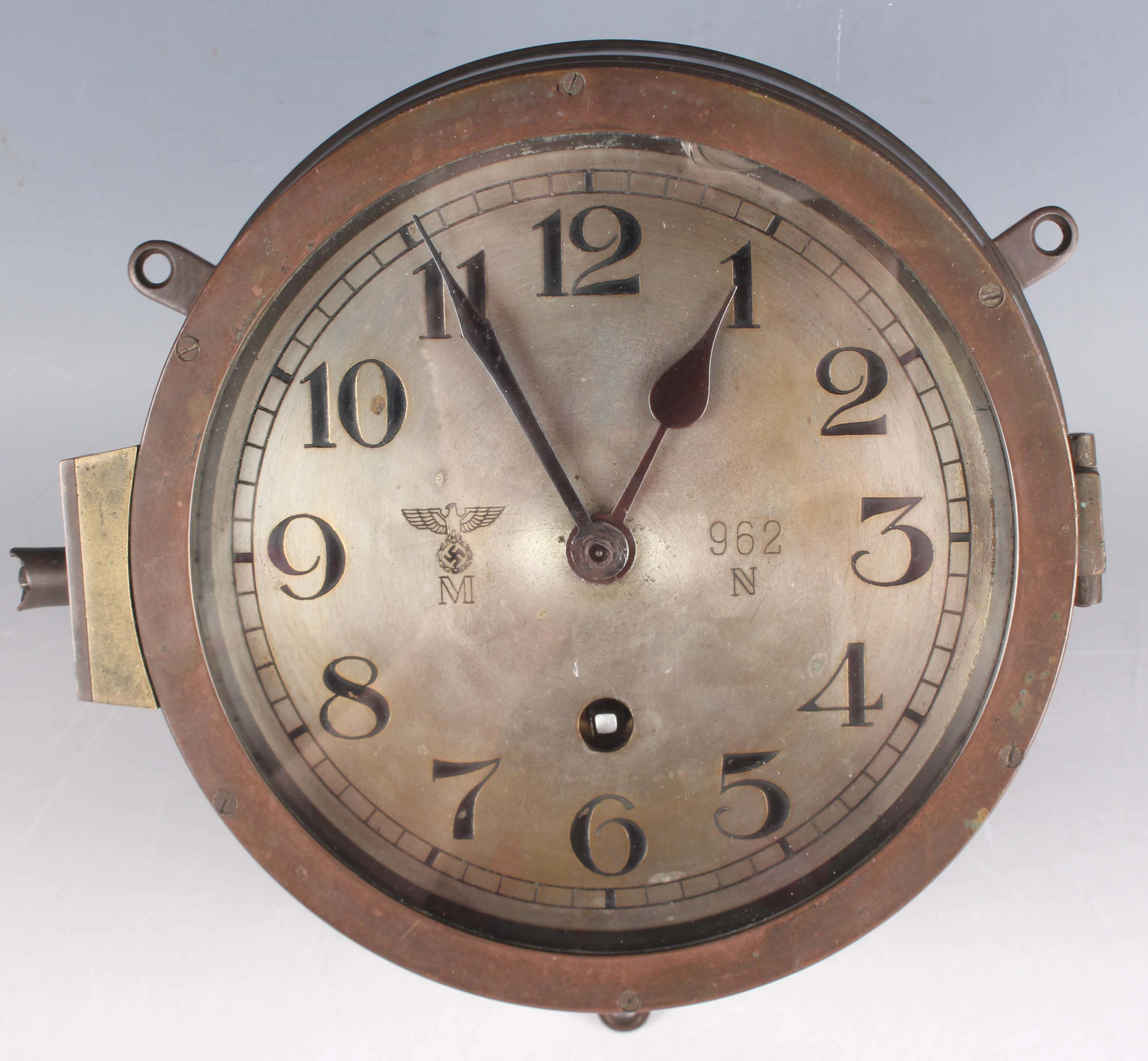 A German Kriegsmarine brass circular cased ship's bulkhead clock timepiece