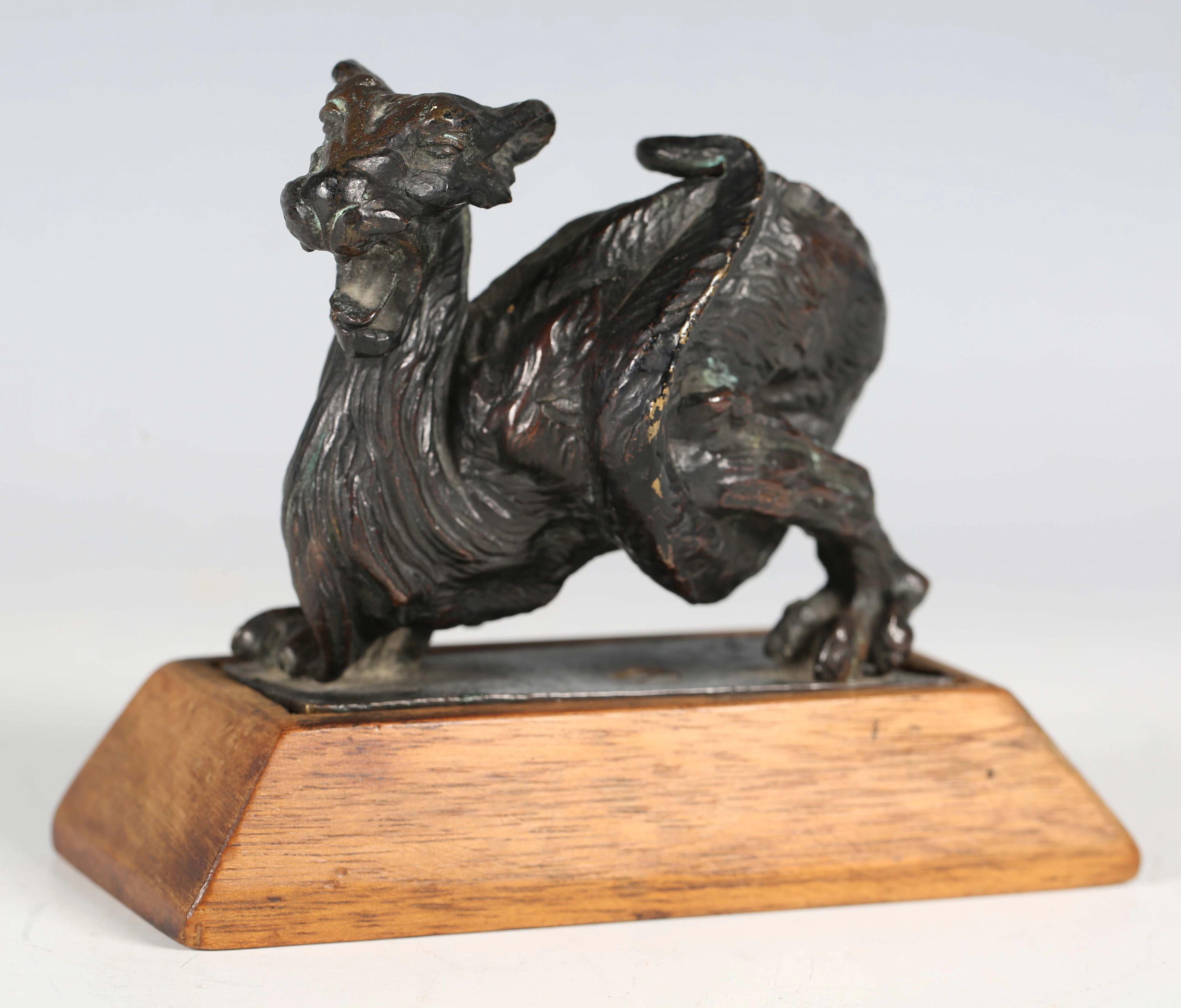 A 19th century bronze model of a mythological beast with entwined