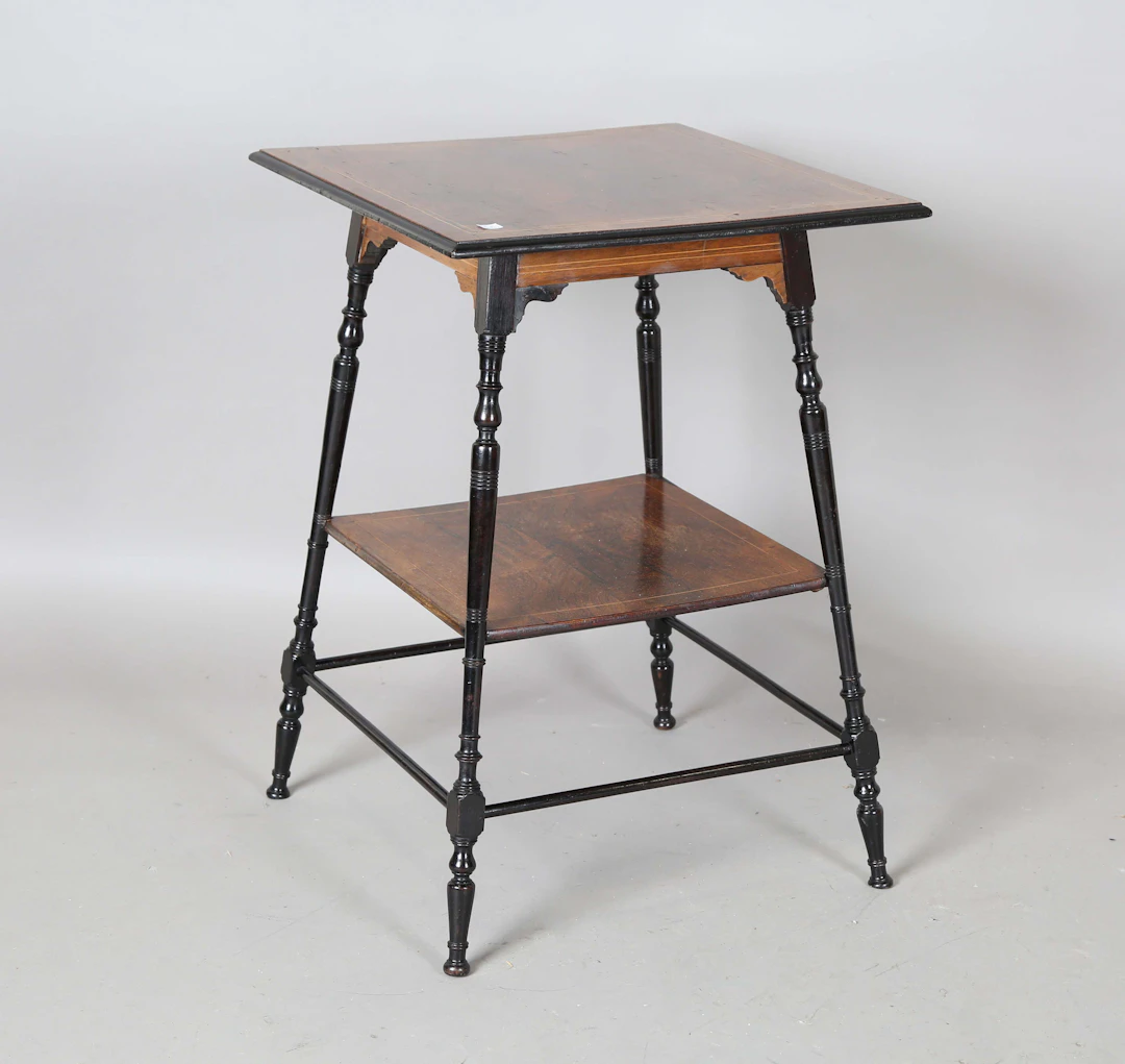 A late Victorian Aesthetic Movement rosewood and ebonized two-tier