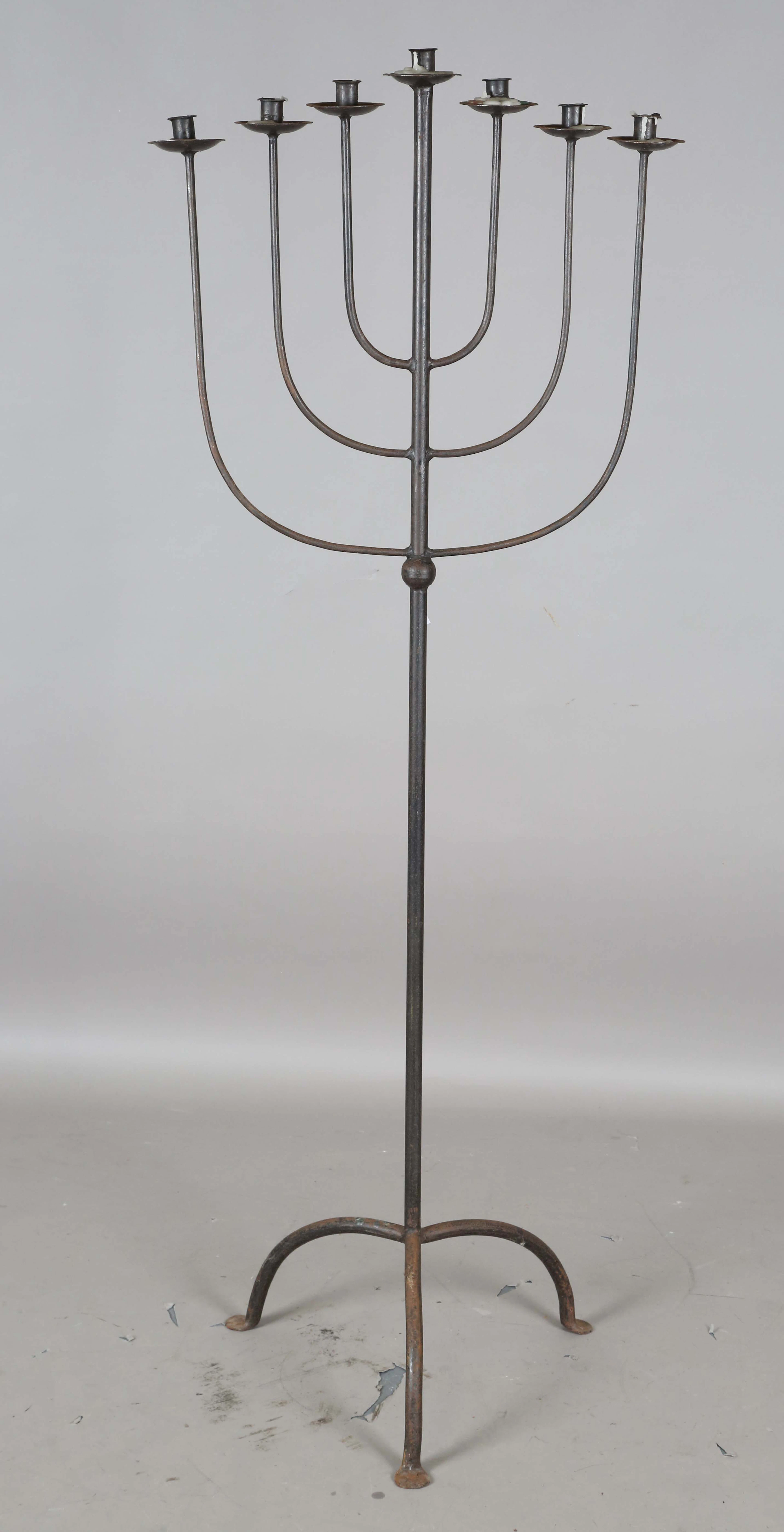 A 20th century wrought iron floor-standing seven-branch menorah, height 160cm.