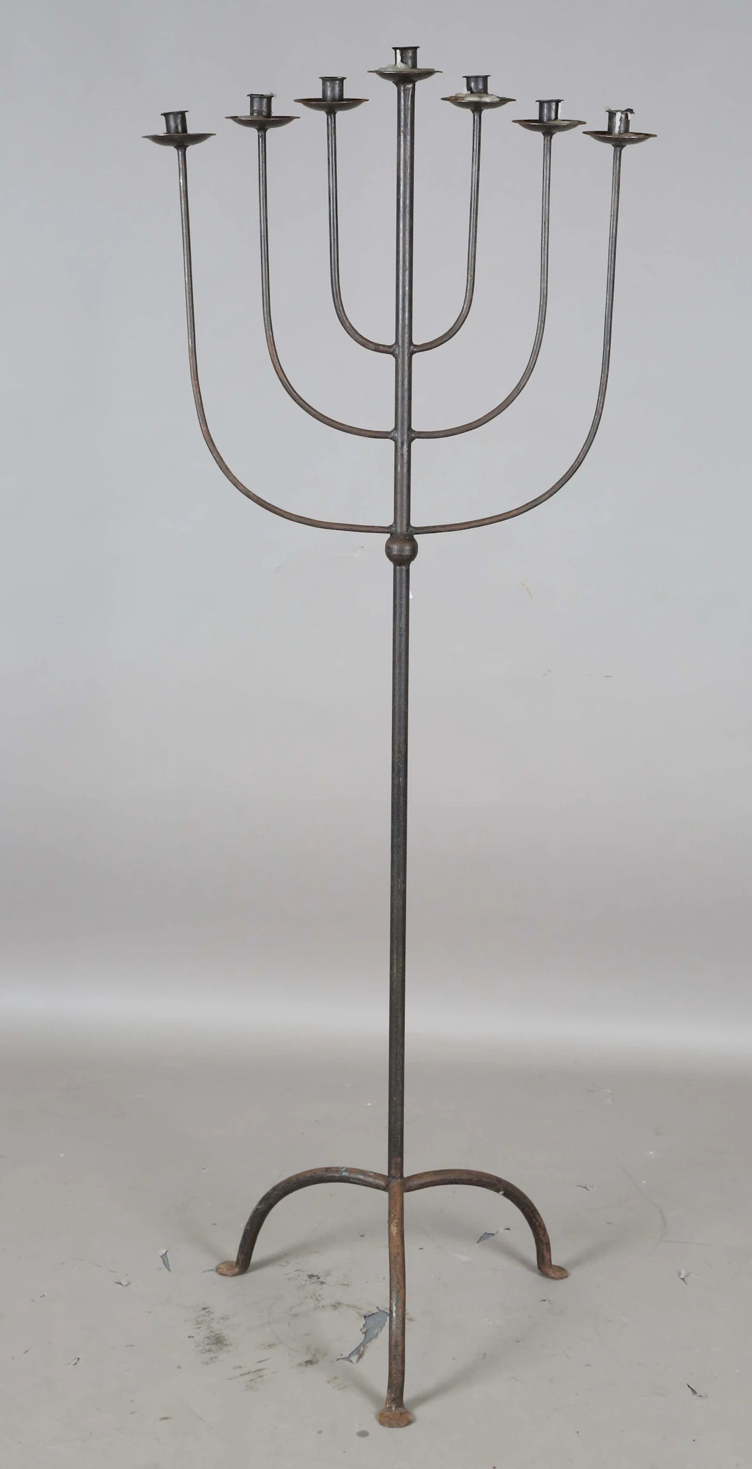 A 20th century wrought iron floor-standing seven-branch menorah, height 160cm.