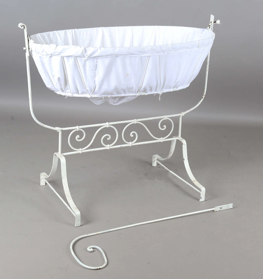 A late Victorian white painted wrought iron rocking crib, length 108cm.
