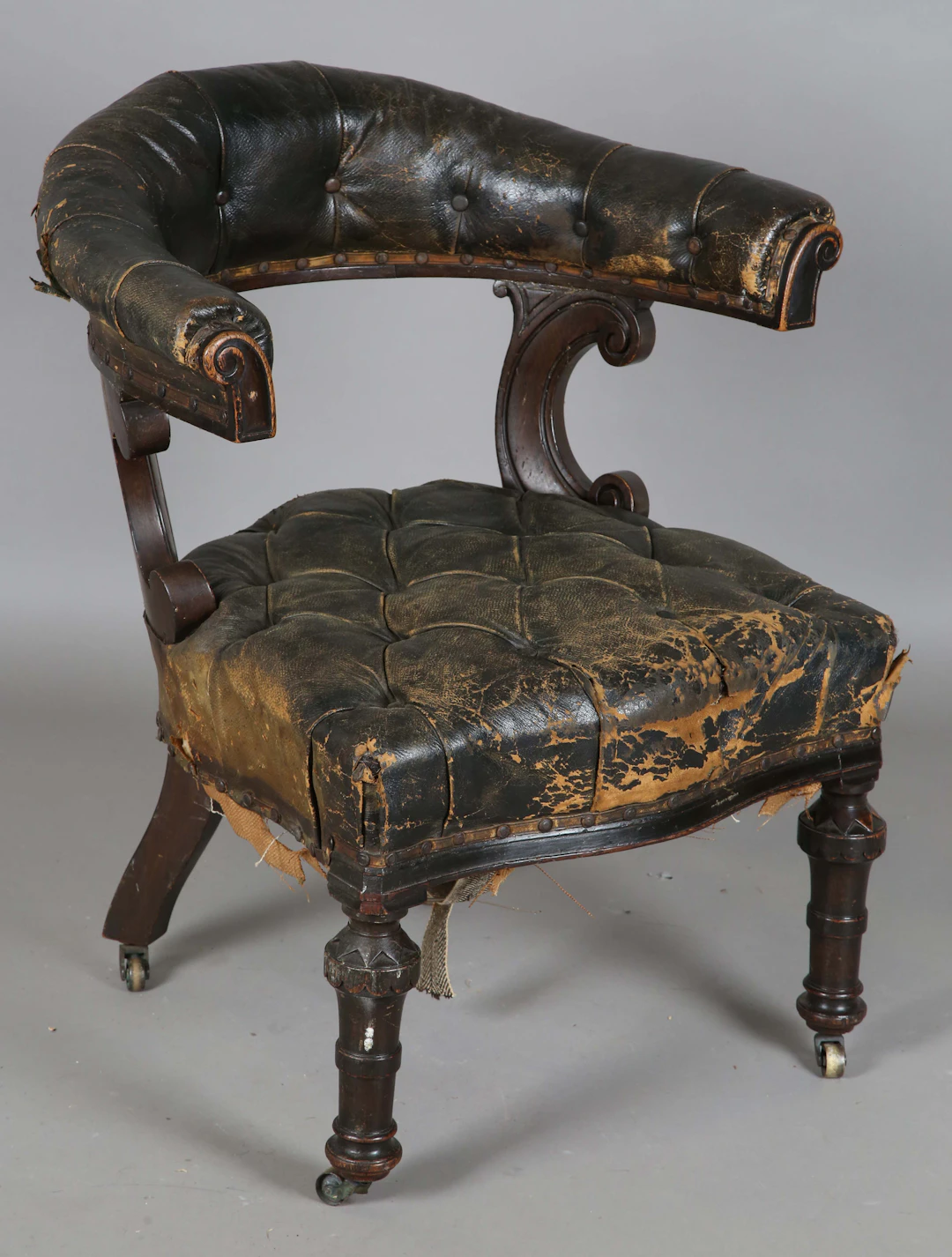 A mid-Victorian oak framed tub back reading chair, upholstered in