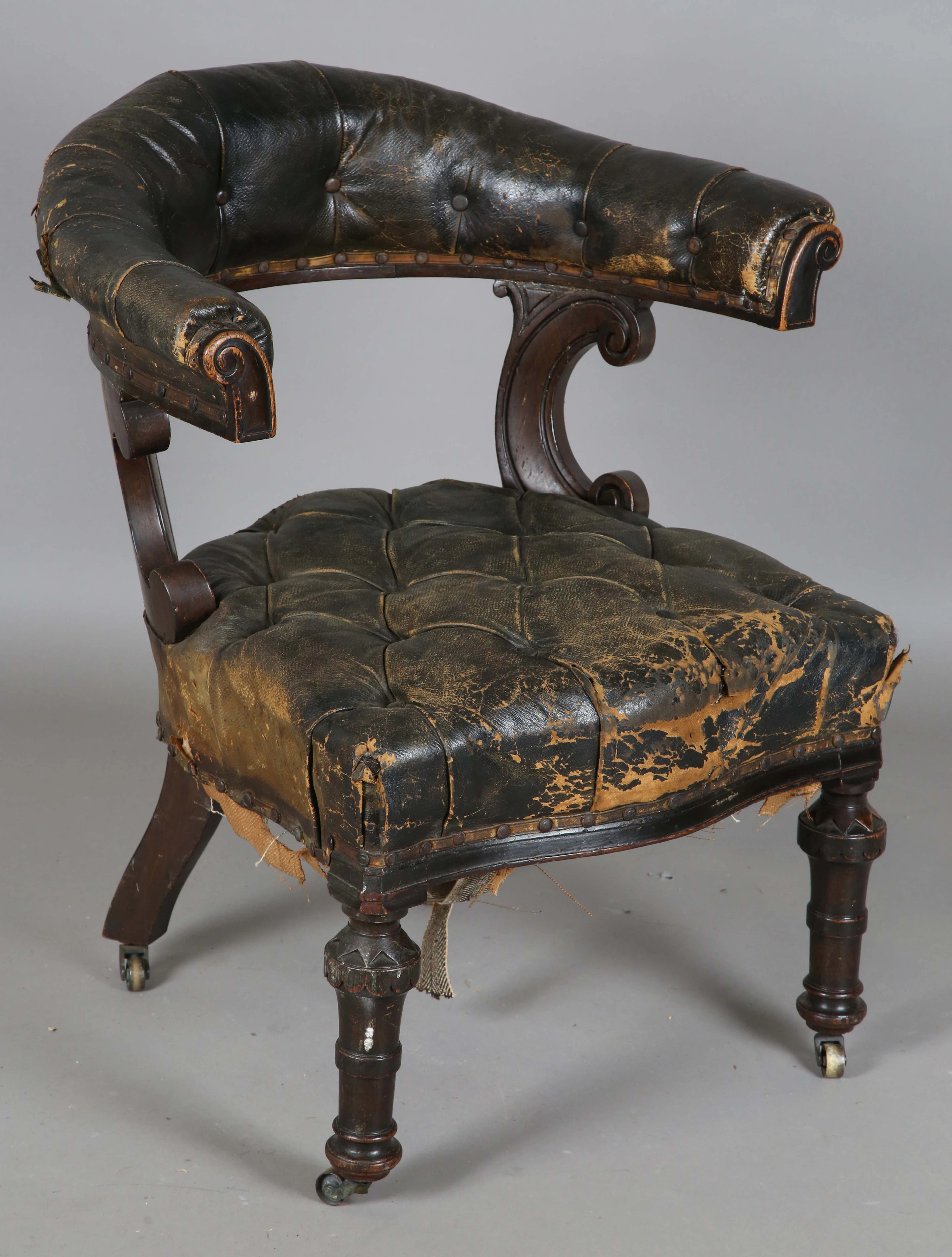 A mid-Victorian oak framed tub back reading chair, upholstered in