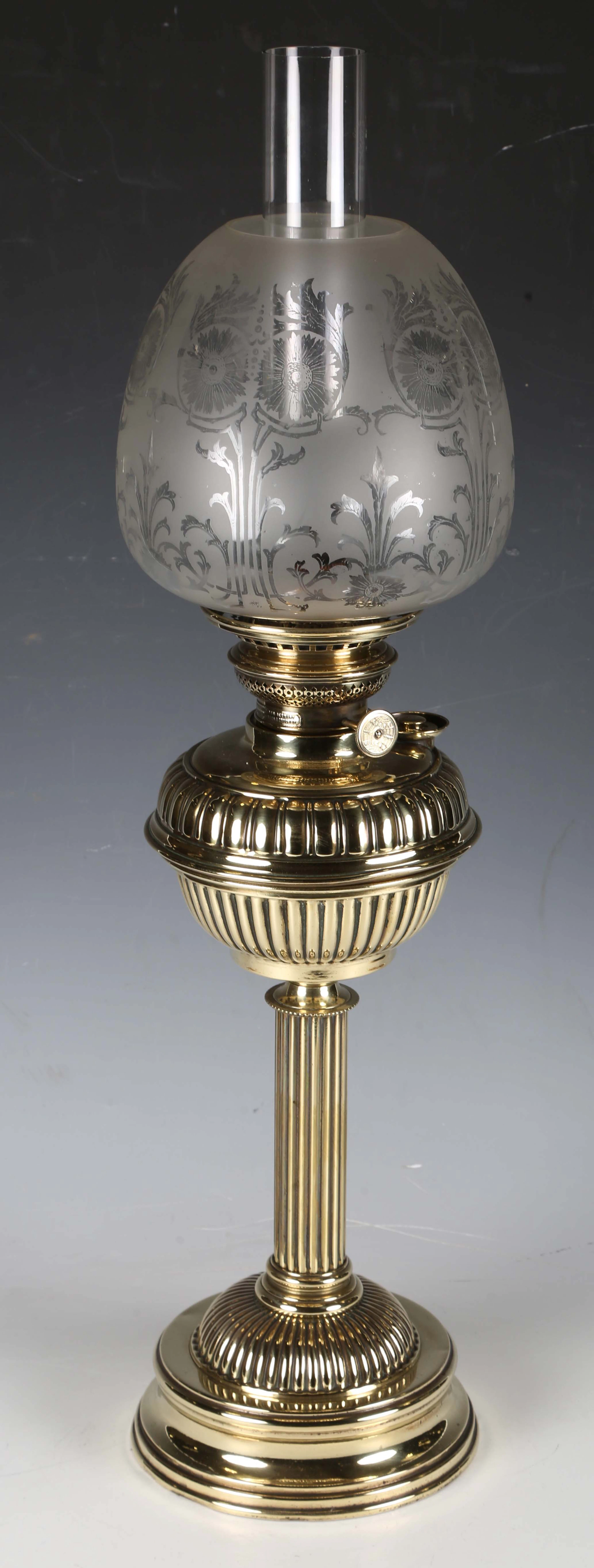 A late Victorian brass table oil lamp with an etched glass shade and
