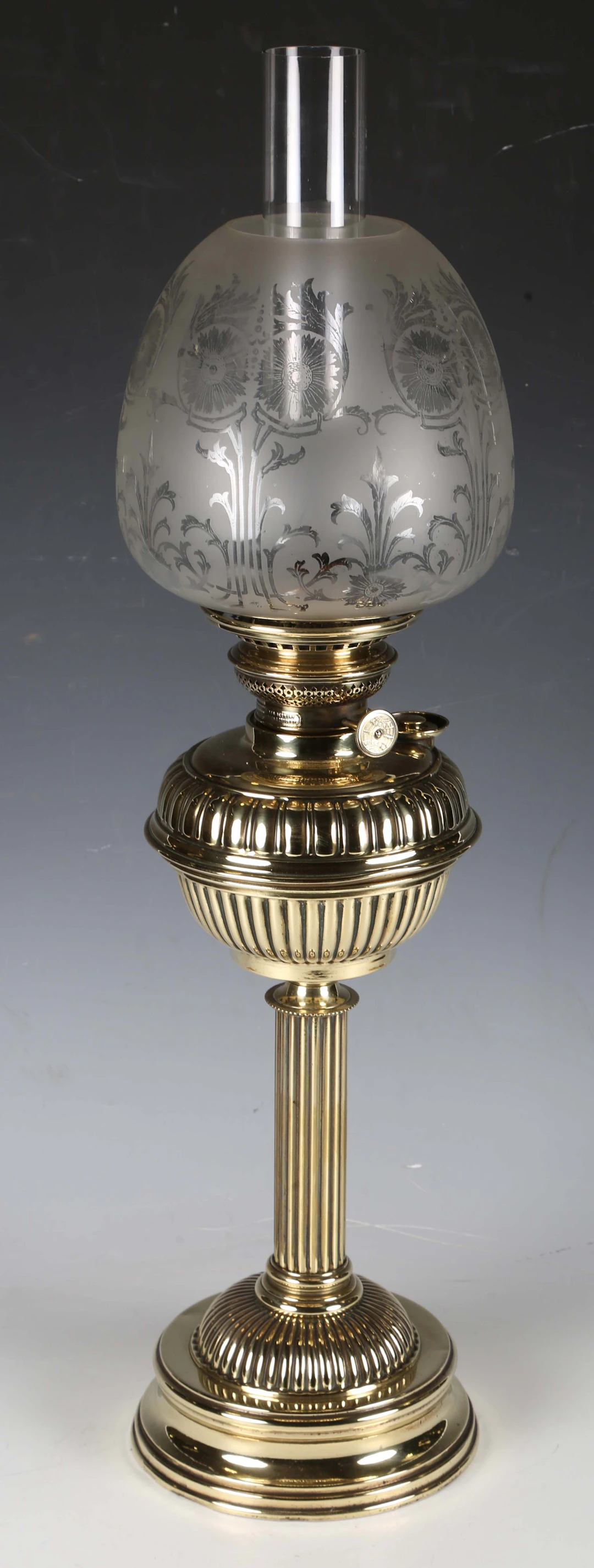 A late Victorian brass table oil lamp with an etched glass shade and