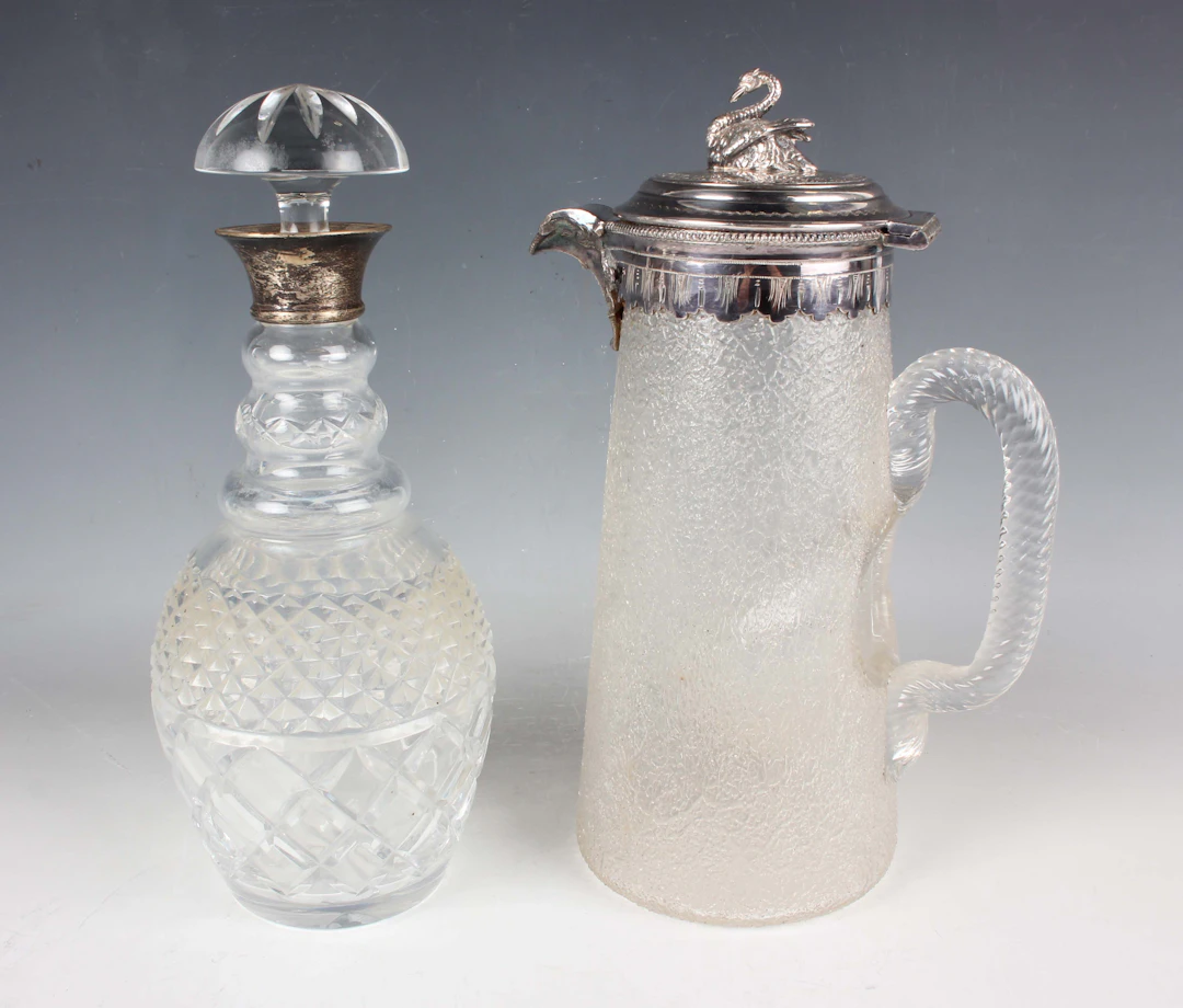 An Elizabeth II silver collared cut glass mallet shaped decanter and