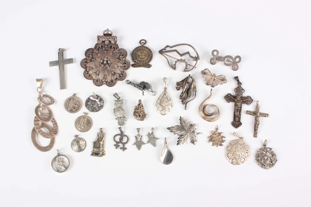 Twenty-eight silver pendants and brooches, including a Navajo style