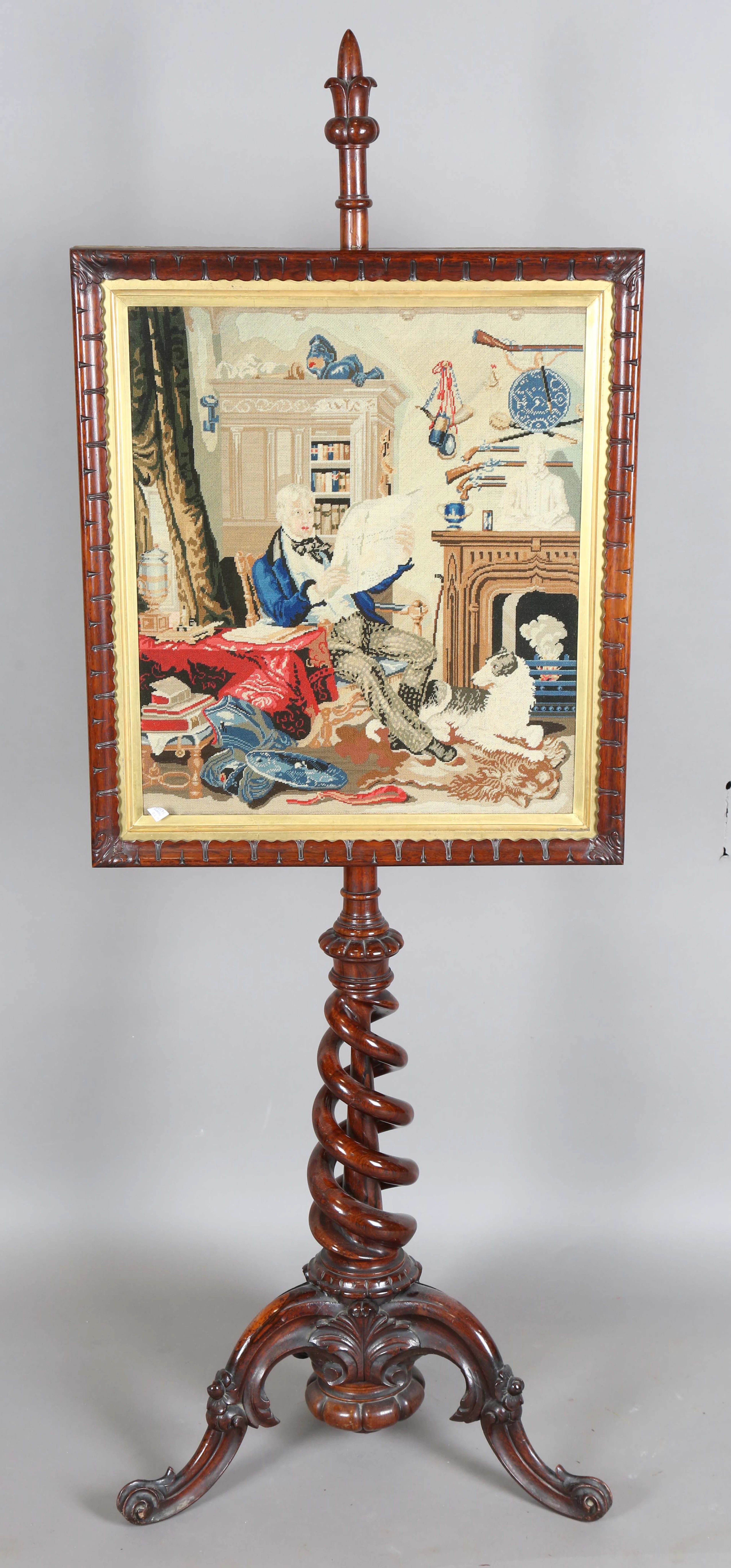 A mid-Victorian rosewood framed polescreen, the rectangular woolwork
