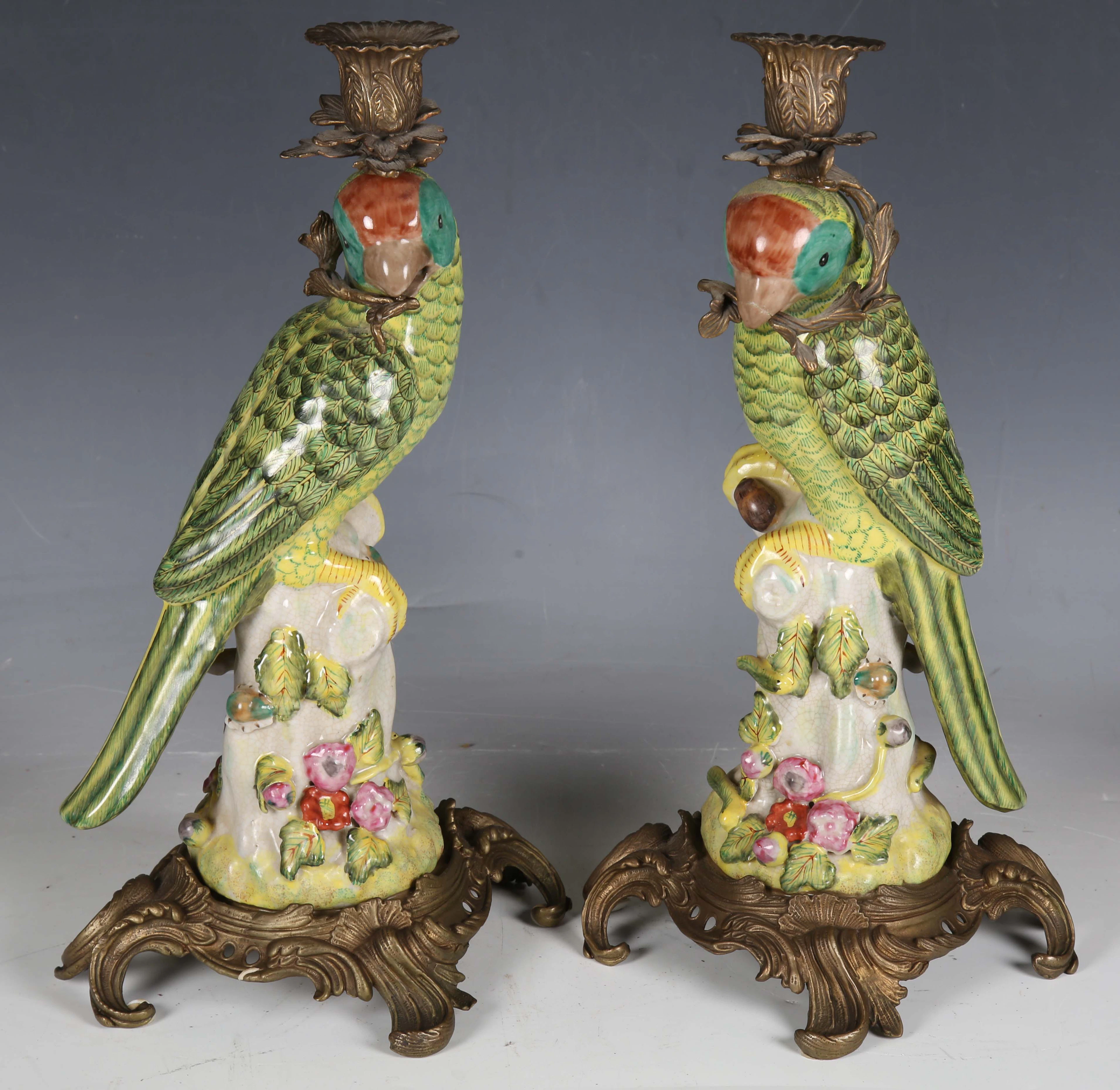 A pair of modern porcelain and gilt metal mounted candlesticks, each