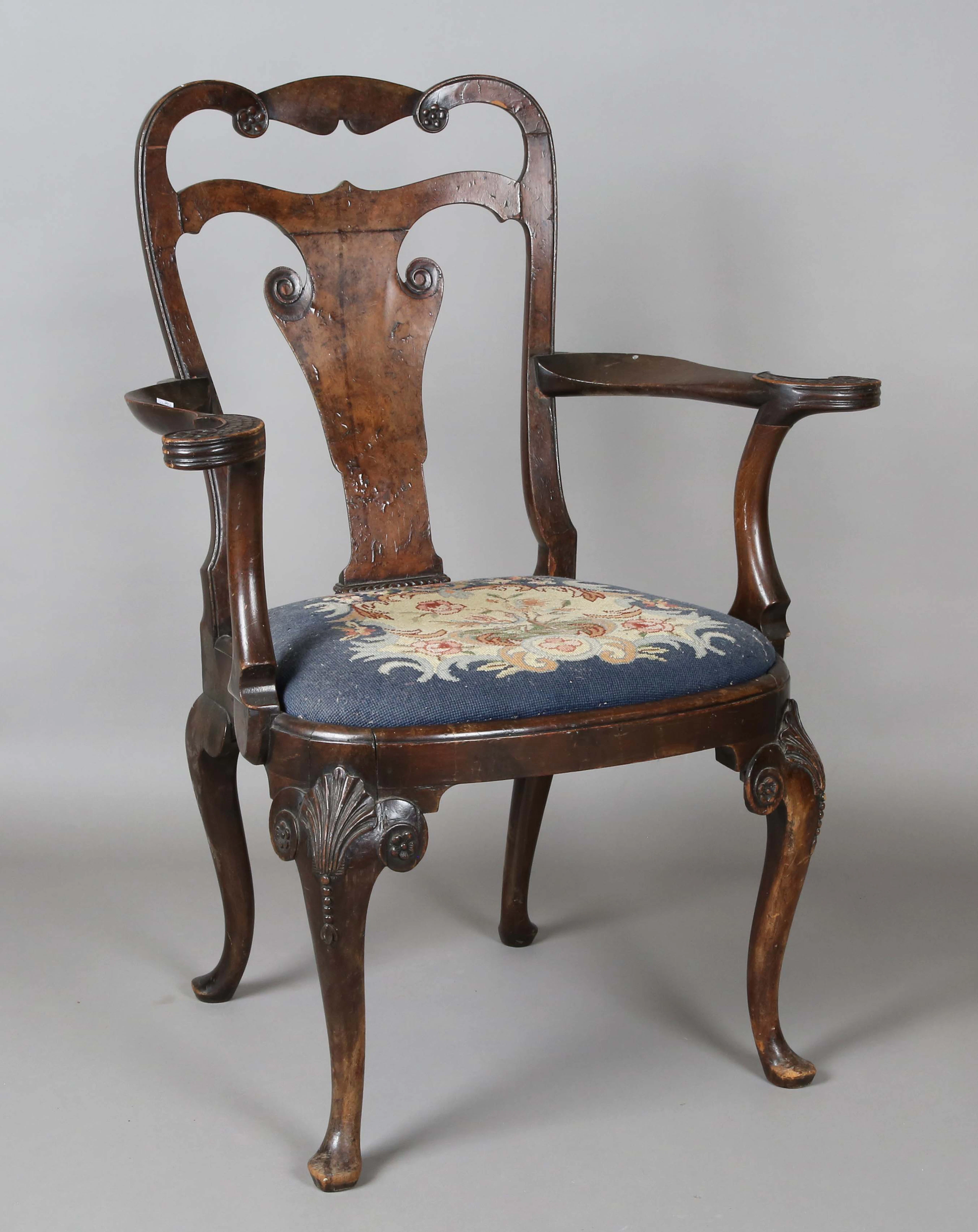 An early 20th century Queen Anne style stained walnut vase back elbow
