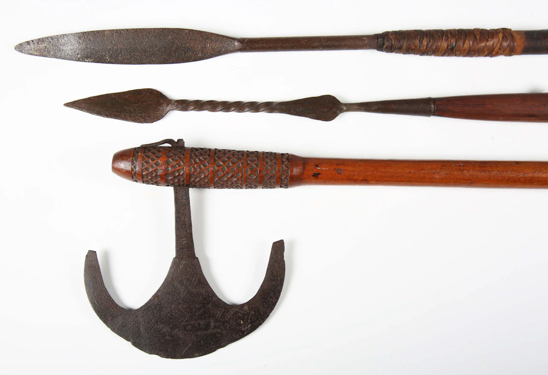 An African throwing axe, the crescent-shaped blade engraved with a