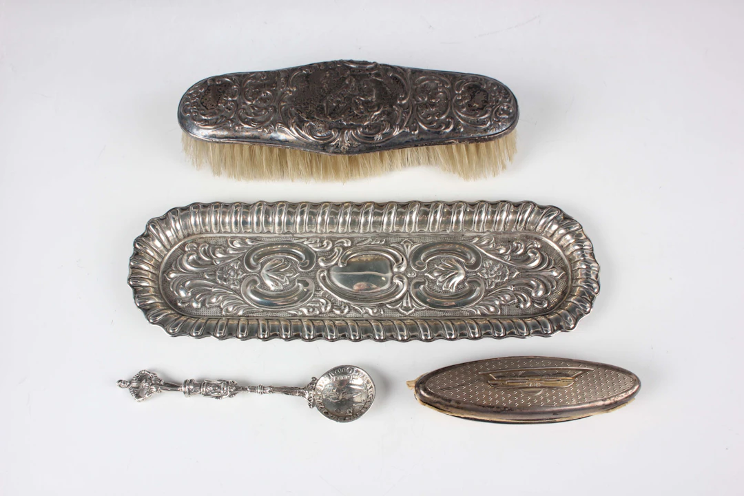 An Edwardian silver curved rectangular dressing table tray, embossed