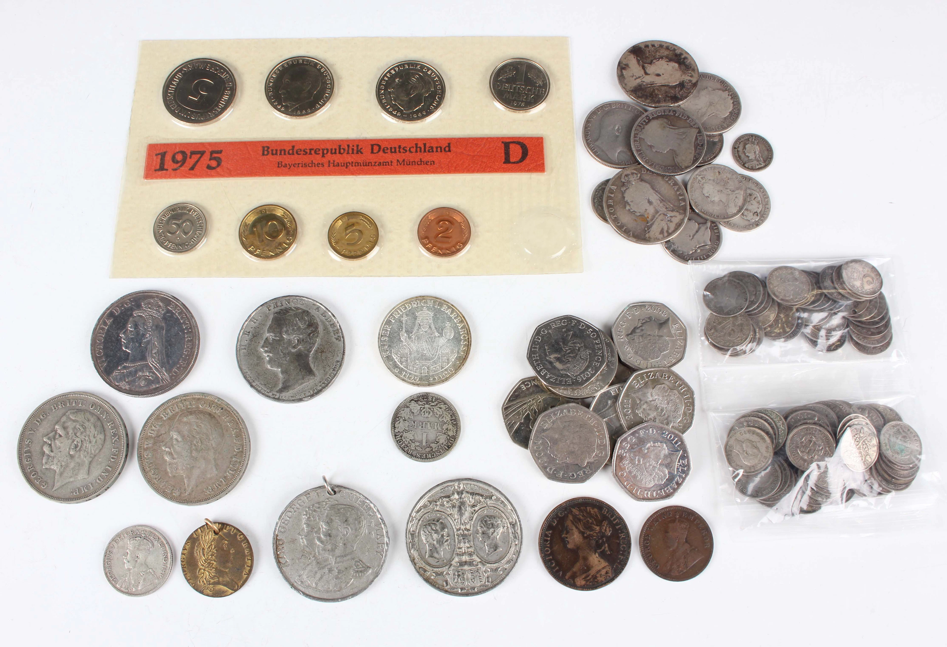A collection of mixed world coins and paranumismatic items, including