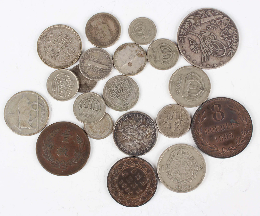 A group of world coins, including a Canada cent 1882 H, a Guernsey