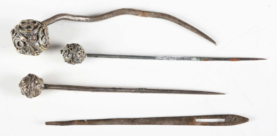 A group of three Tudor period pins, each with a gilded strapwork spherical