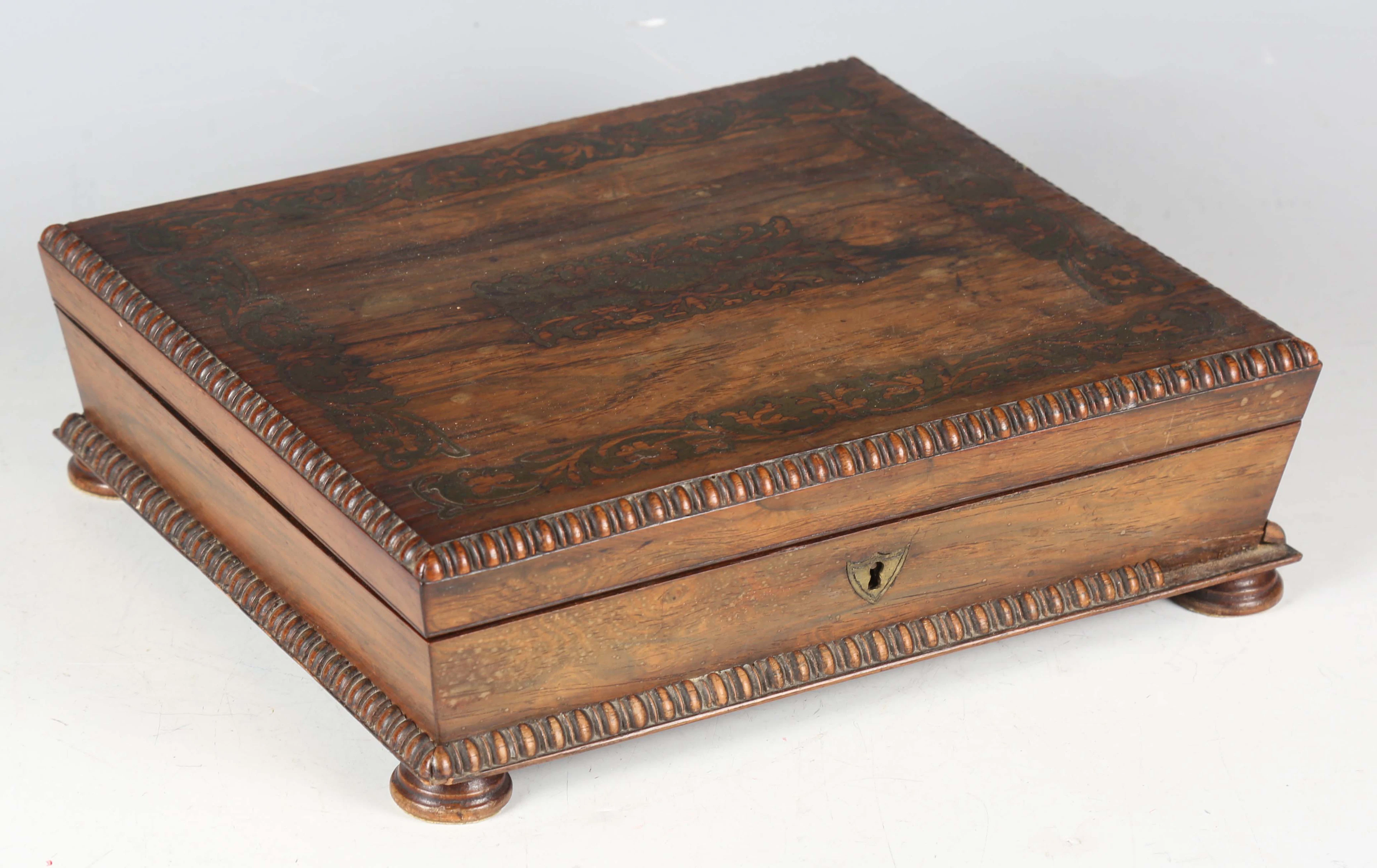 A Regency rosewood and brass inlaid workbox with bead and reel moulded