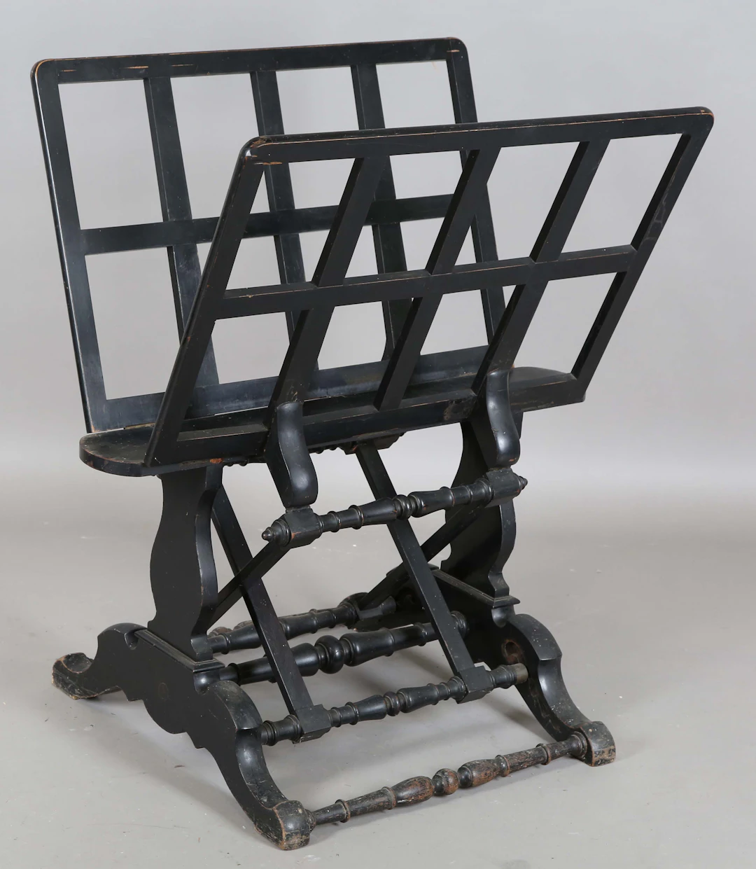 A mid-Victorian ebonized folio stand with ratchet mechanism folding