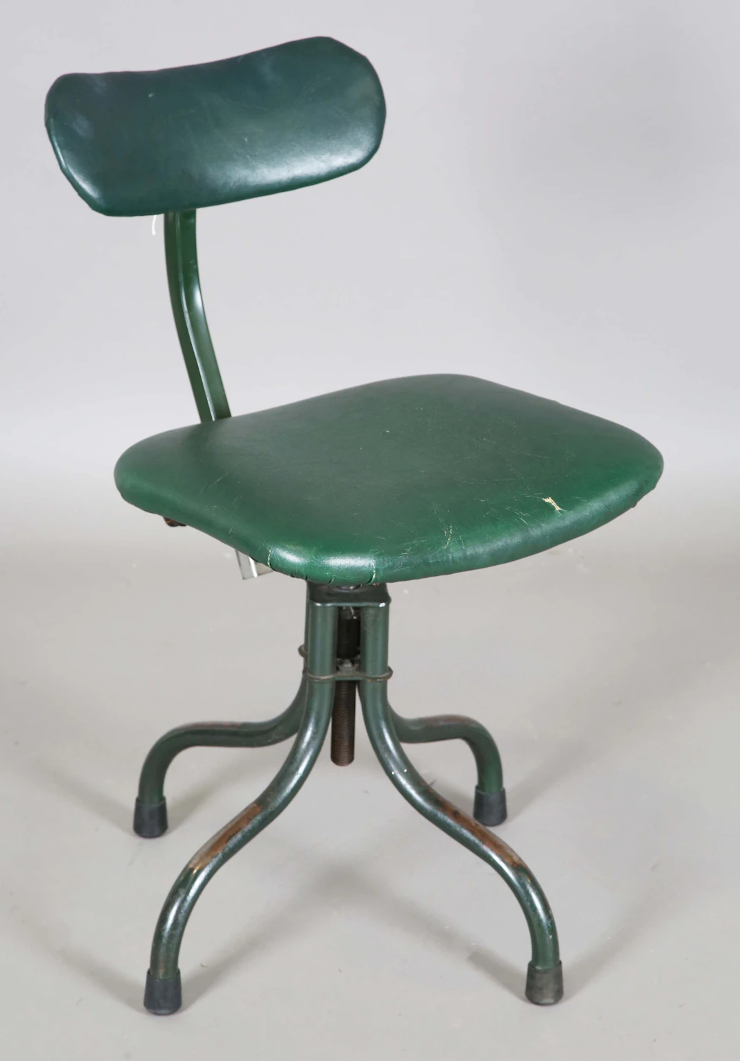 A mid-20th century green painted Tan-Sad industrial swivel chair with