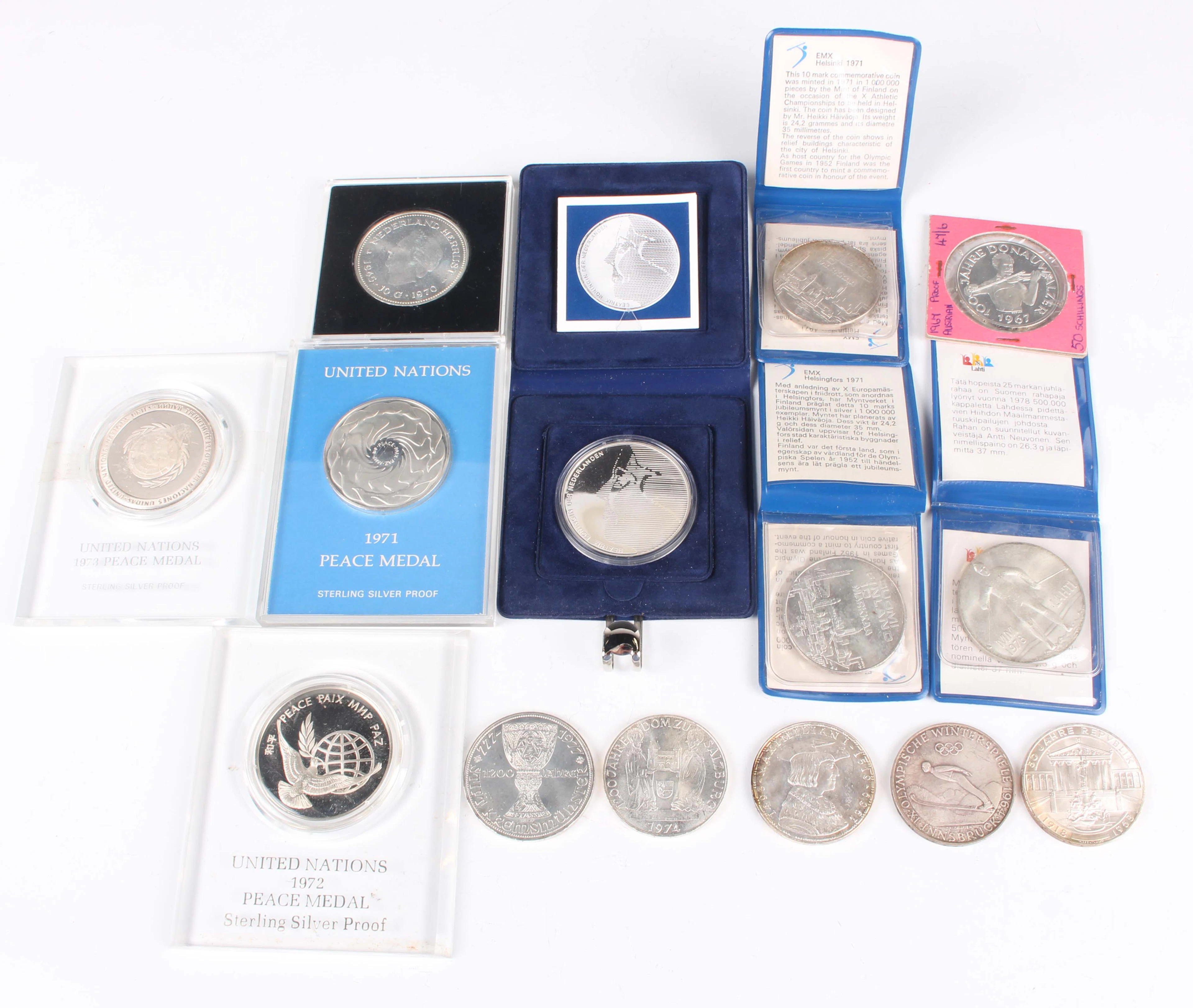 A collection of European silver coins and medallions, including three