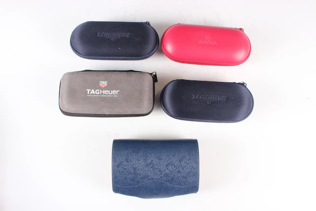 An Omega red service/travel case, length 16.2cm, together with two
