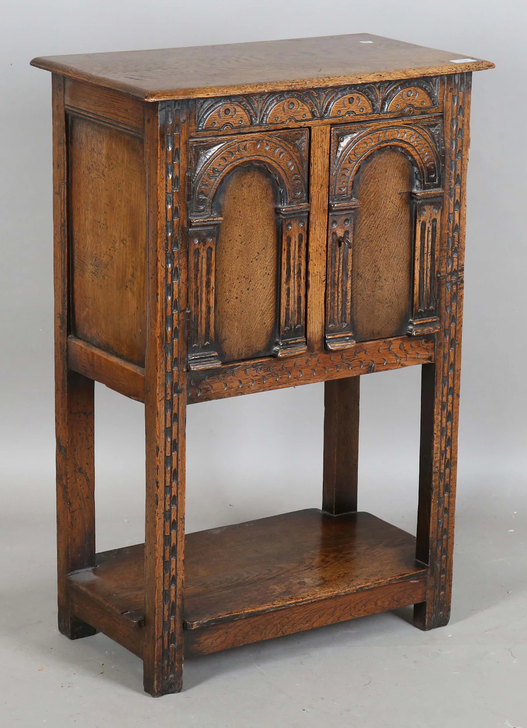 A mid-20th century Carolean Revival oak side cabinet, fitted with