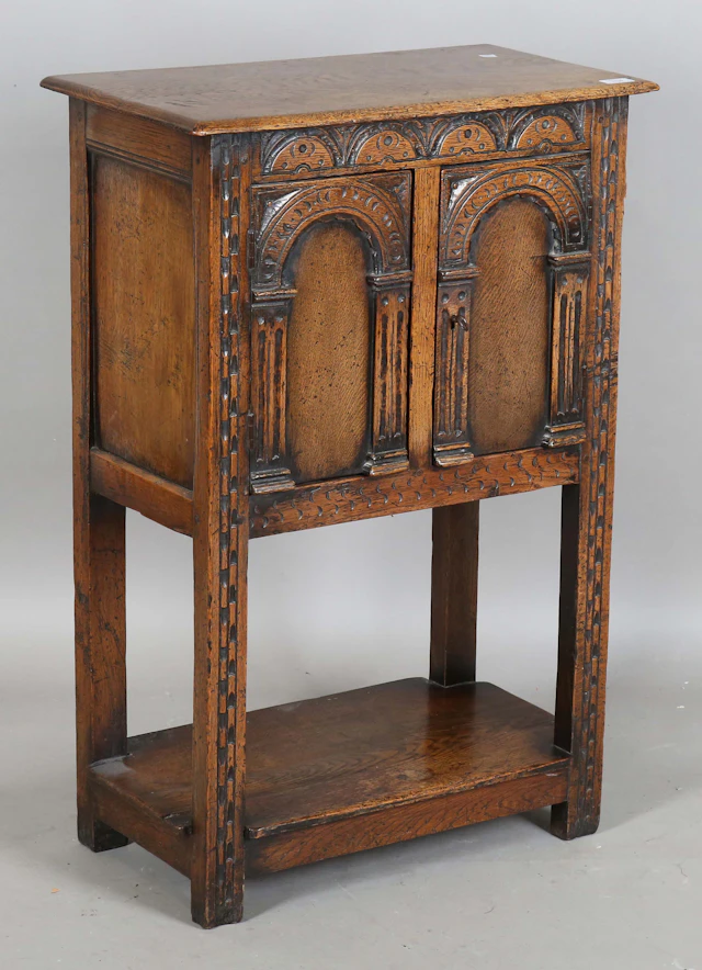 A mid-20th century Carolean Revival oak side cabinet, fitted with