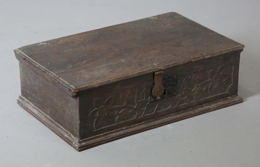 A 17th century oak bible box with carved front, height 17cm, width
