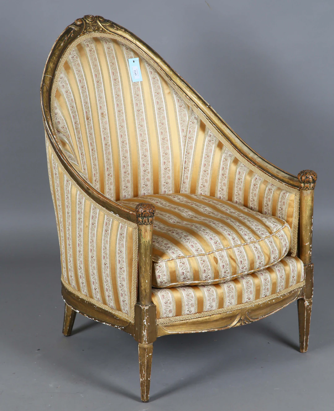An early 20th century French giltwood tub back salon chair, attributed