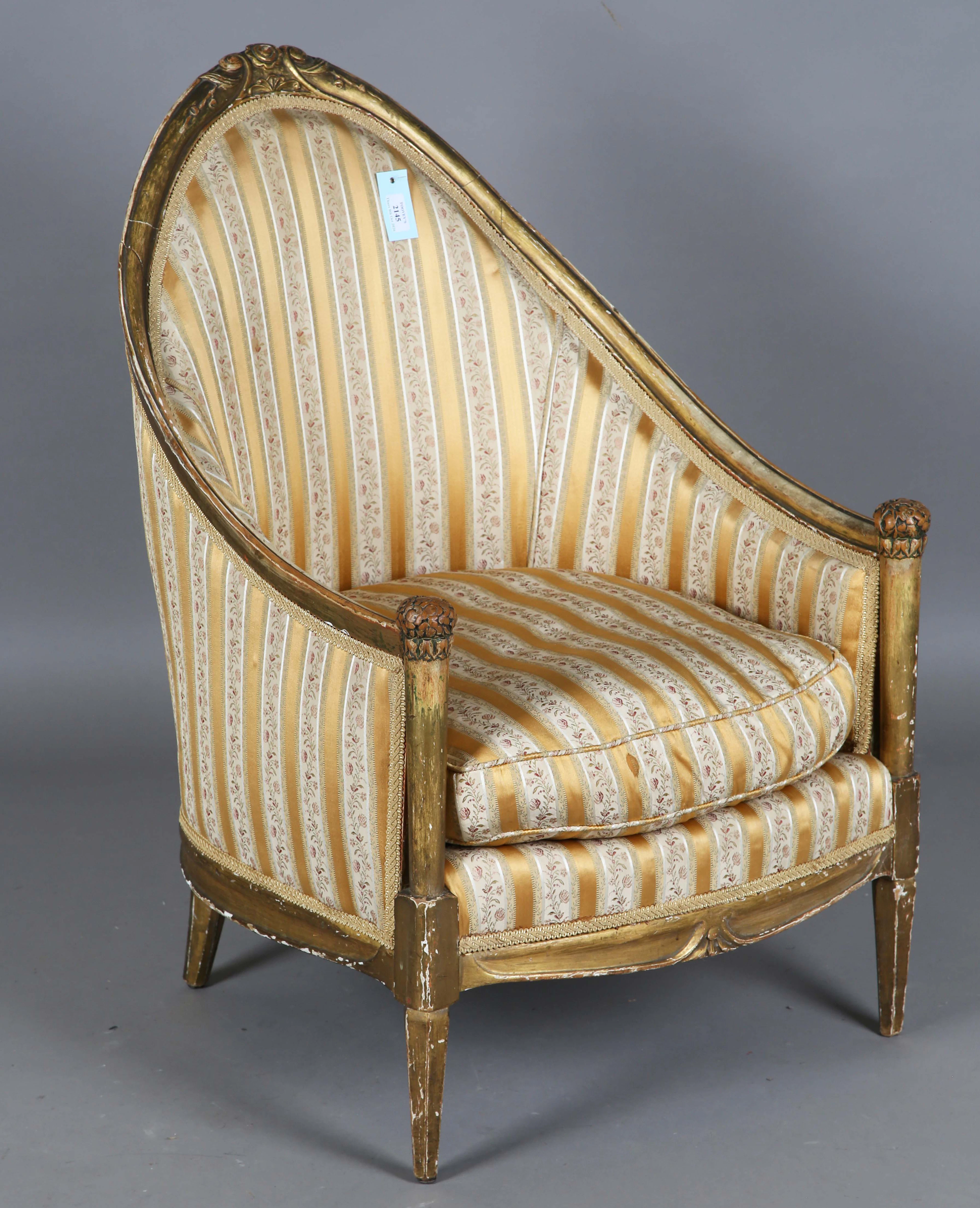 An early 20th century French giltwood tub back salon chair, attributed