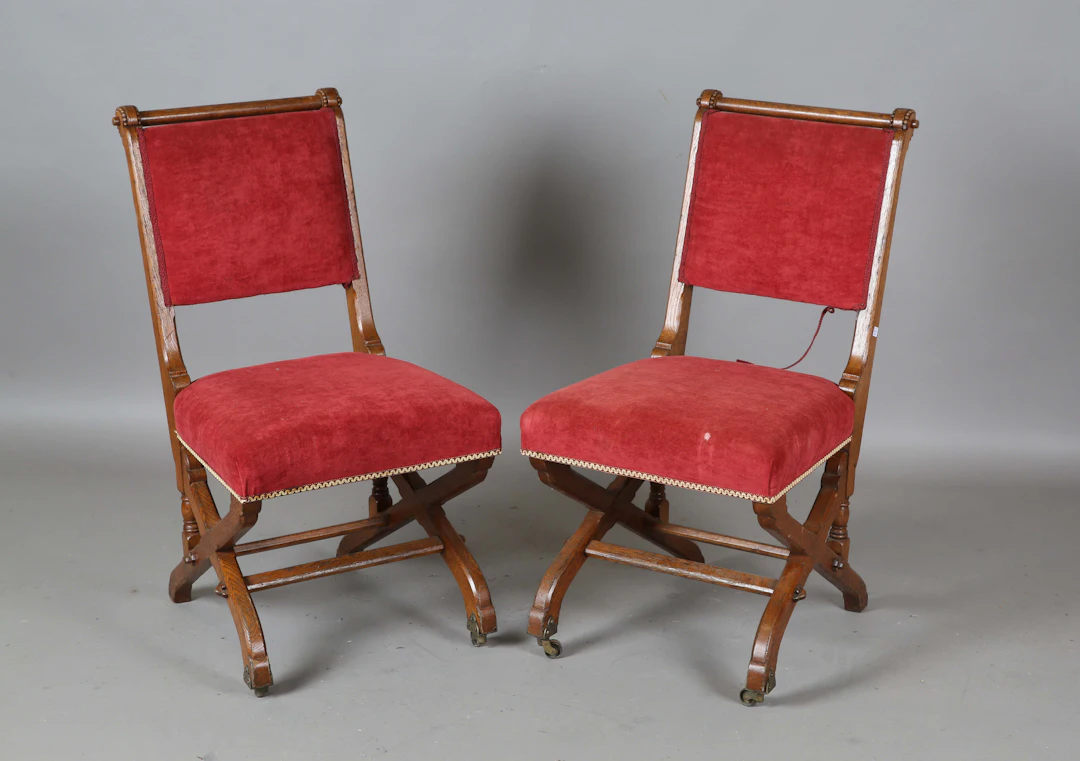 A pair of late Victorian Gothic Revival oak framed side chairs by