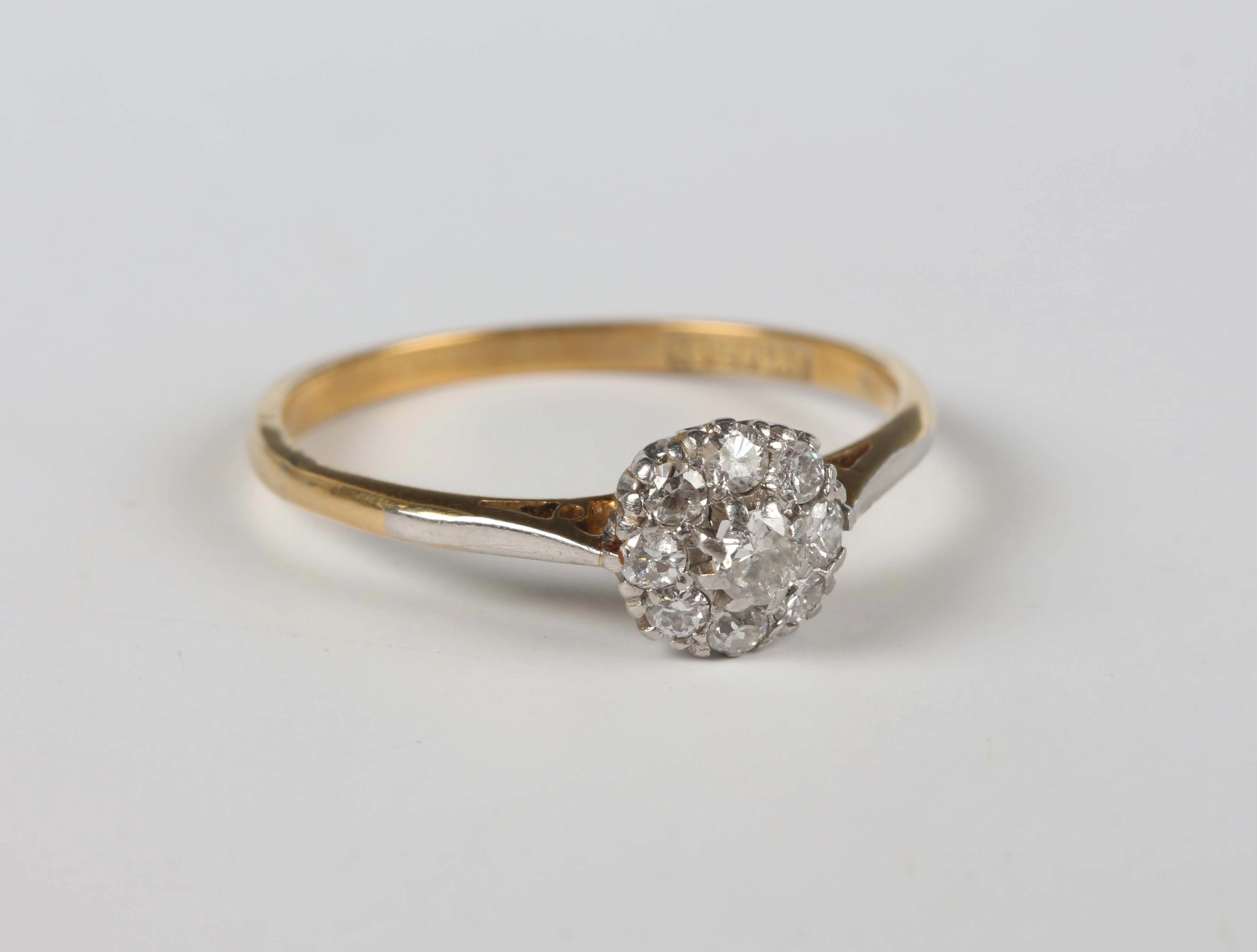 A gold, platinum and diamond cluster ring, mounted with the principal