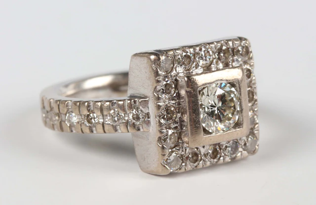 A white gold and diamond square cluster ring, mounted with the principal