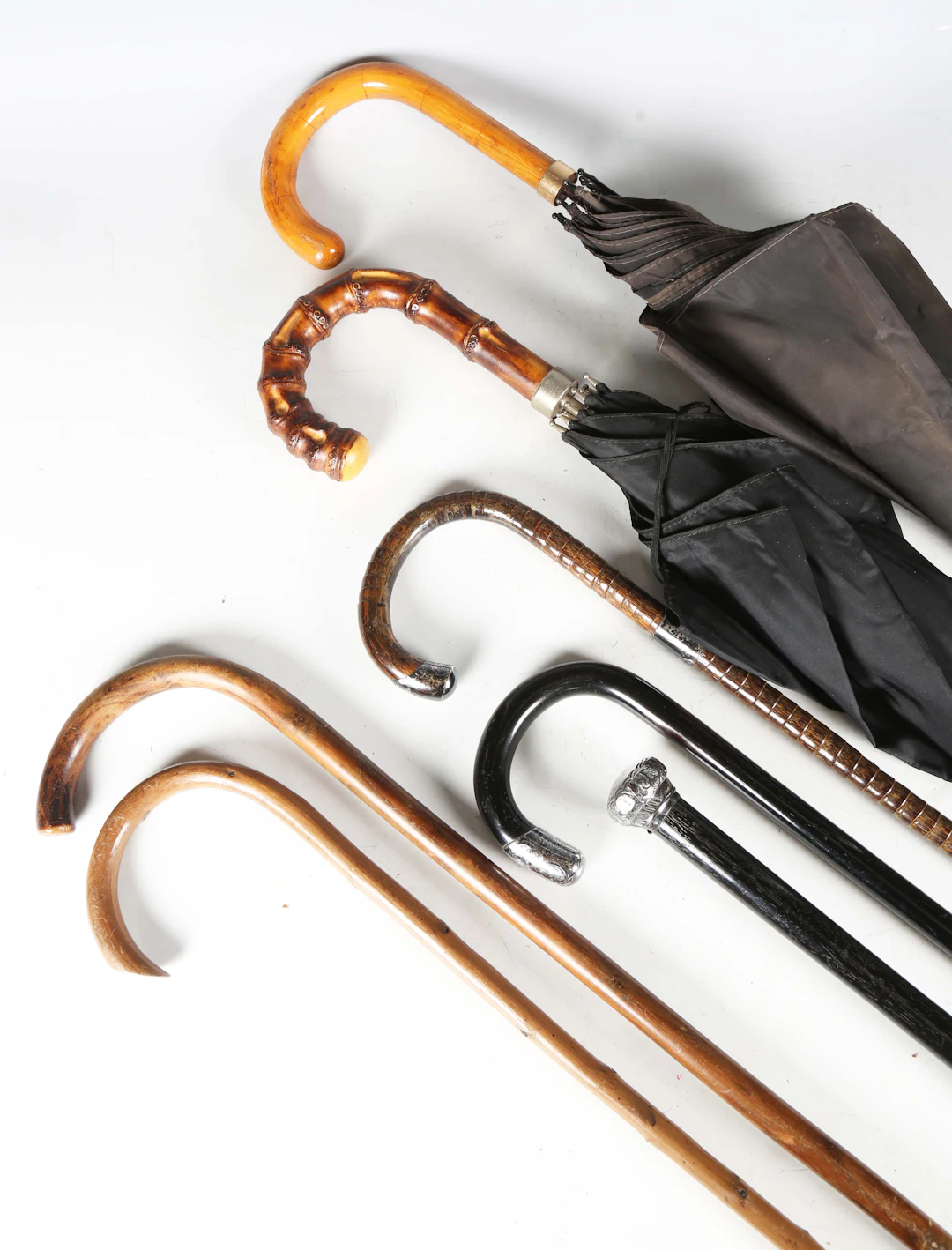 Three early 20th century silver mounted walking sticks, two other