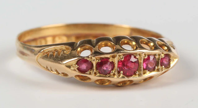 An 18ct gold and ruby five stone ring, mounted with a row of graduated