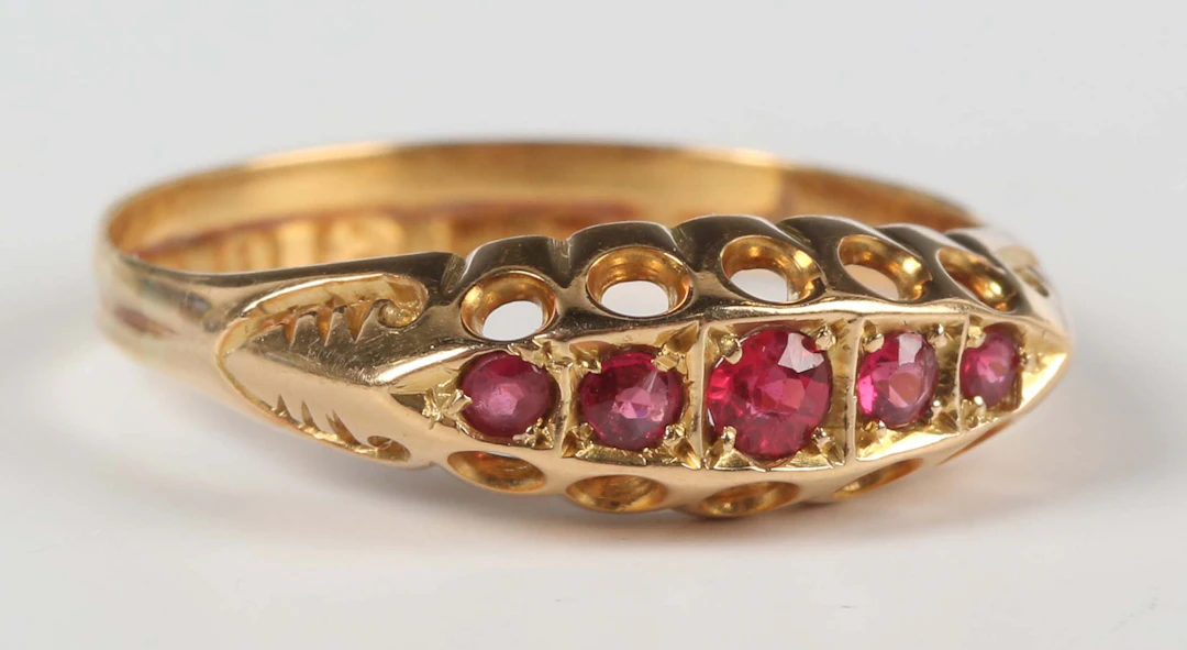 An 18ct gold and ruby five stone ring, mounted with a row of graduated