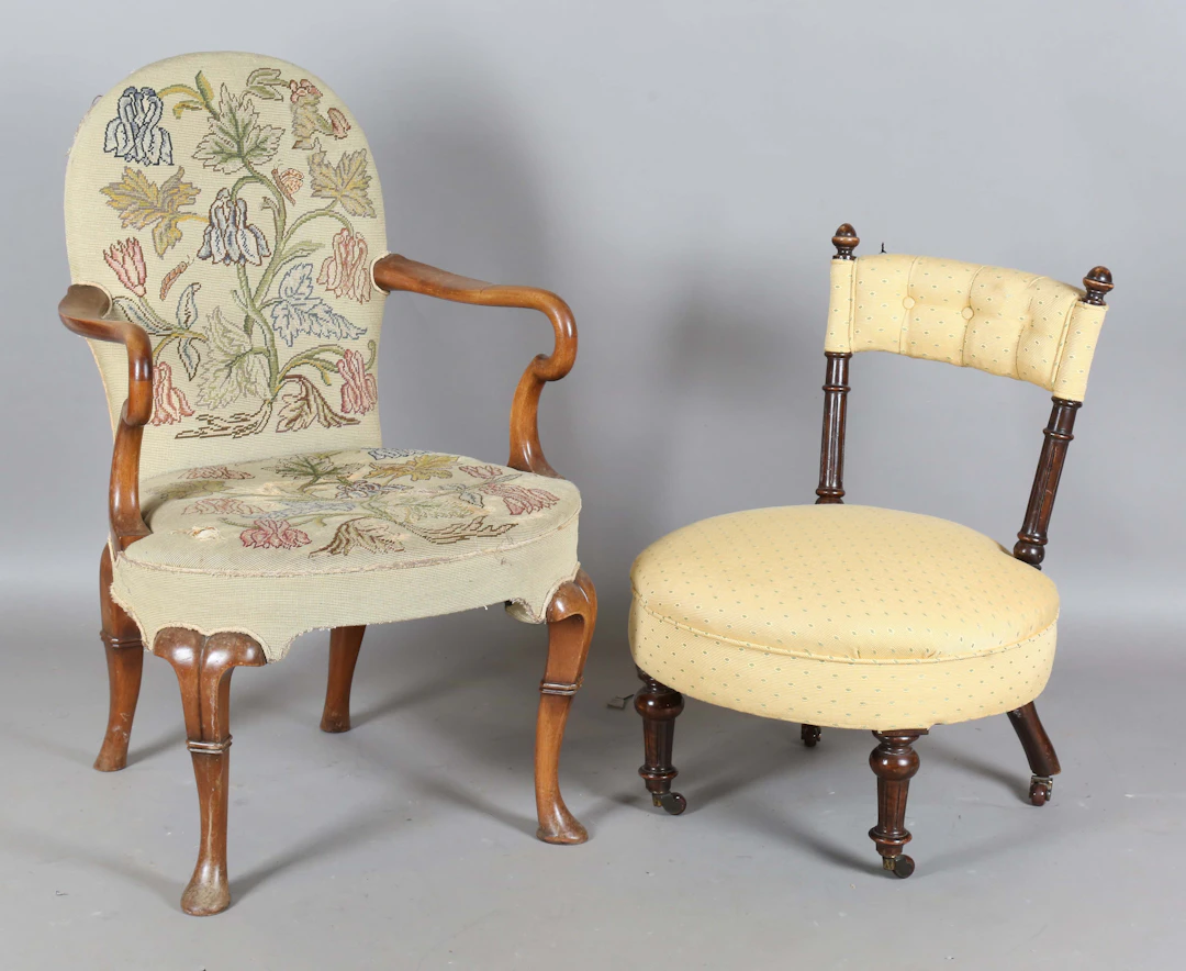 An early 20th century Queen Anne style walnut framed elbow chair with