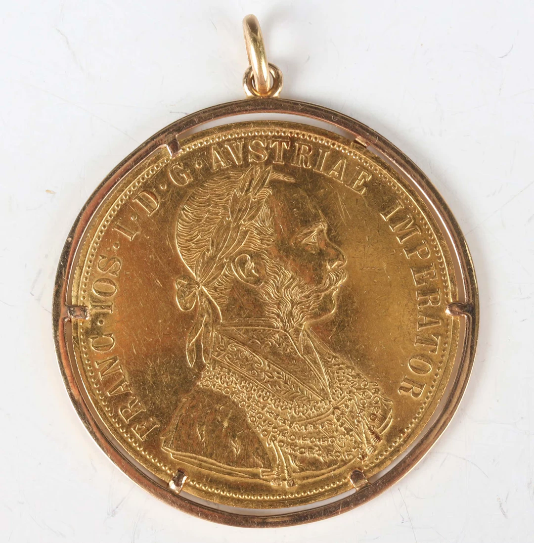 An Austria gold four ducats restrike, dated 1915, within a pinch claw