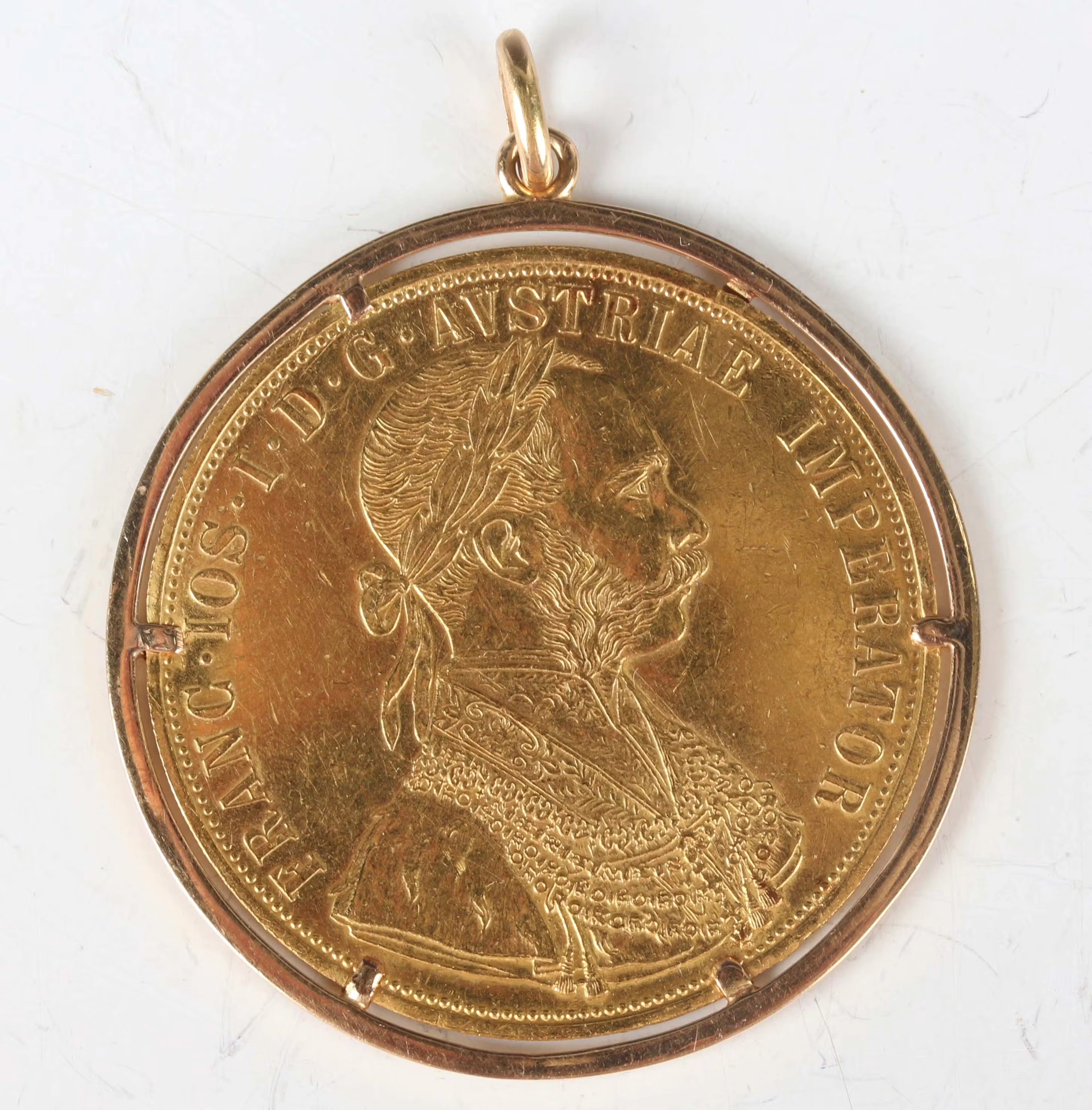 An Austria gold four ducats restrike, dated 1915, within a pinch claw