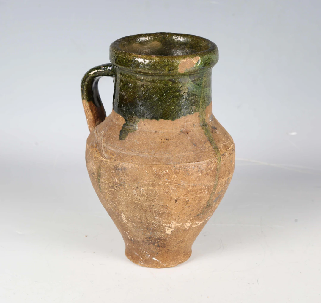 A European pottery jug, probably 18th/19th century, the rim and handle