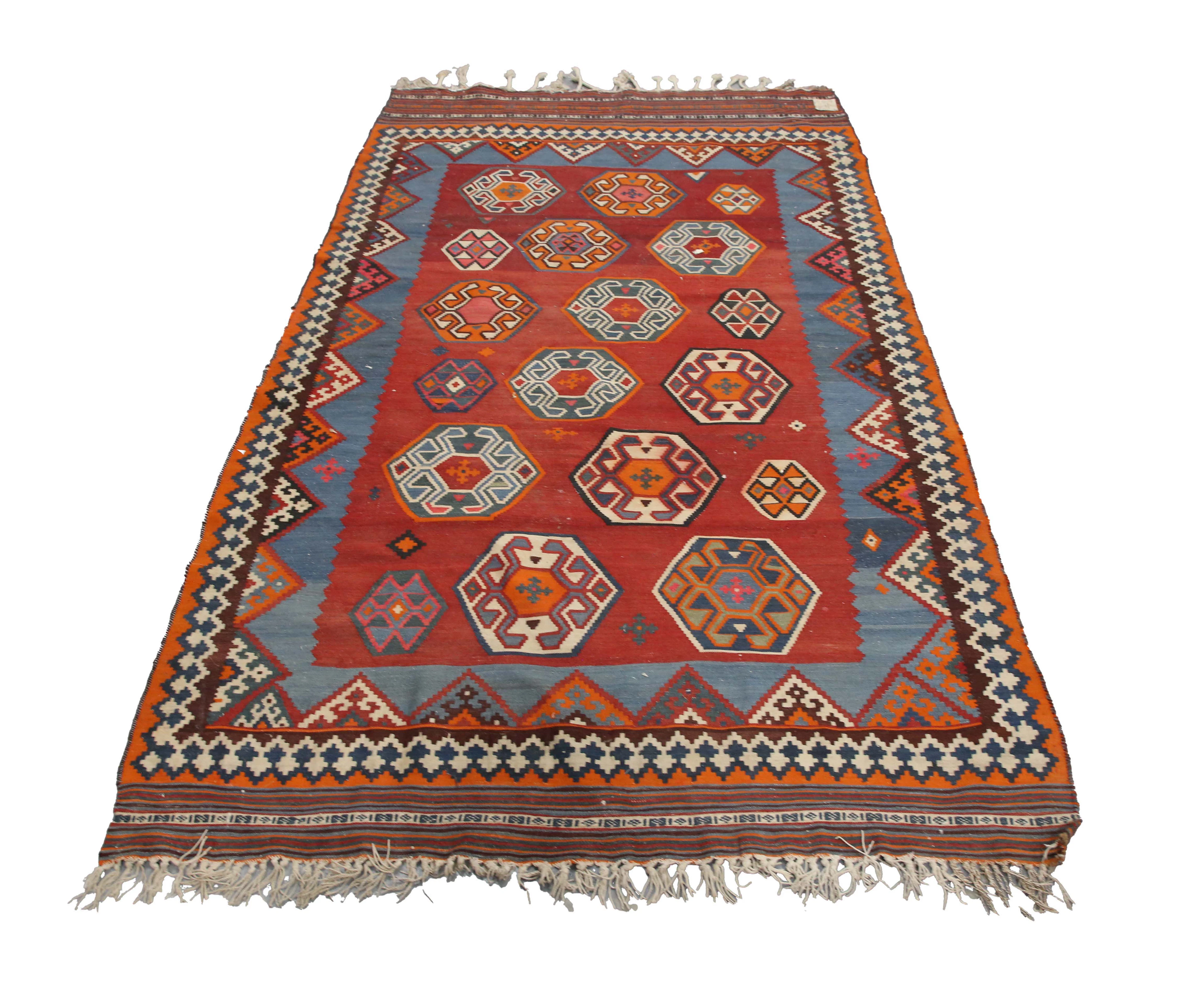 A Persian kilim rug, mid-20th century, the red field with overall