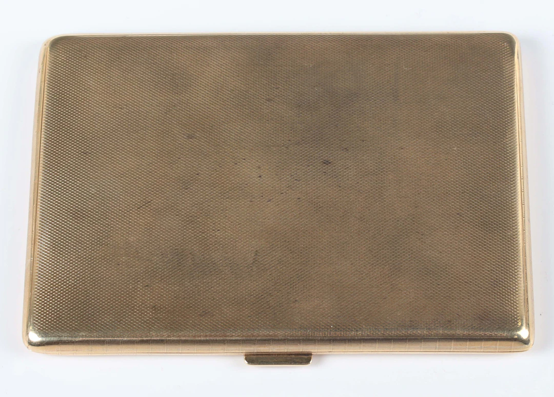 A 9ct gold rectangular cigarette case with engine turned decoration