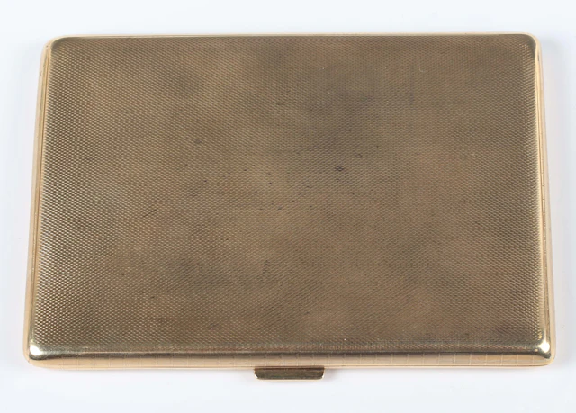 A 9ct gold rectangular cigarette case with engine turned decoration