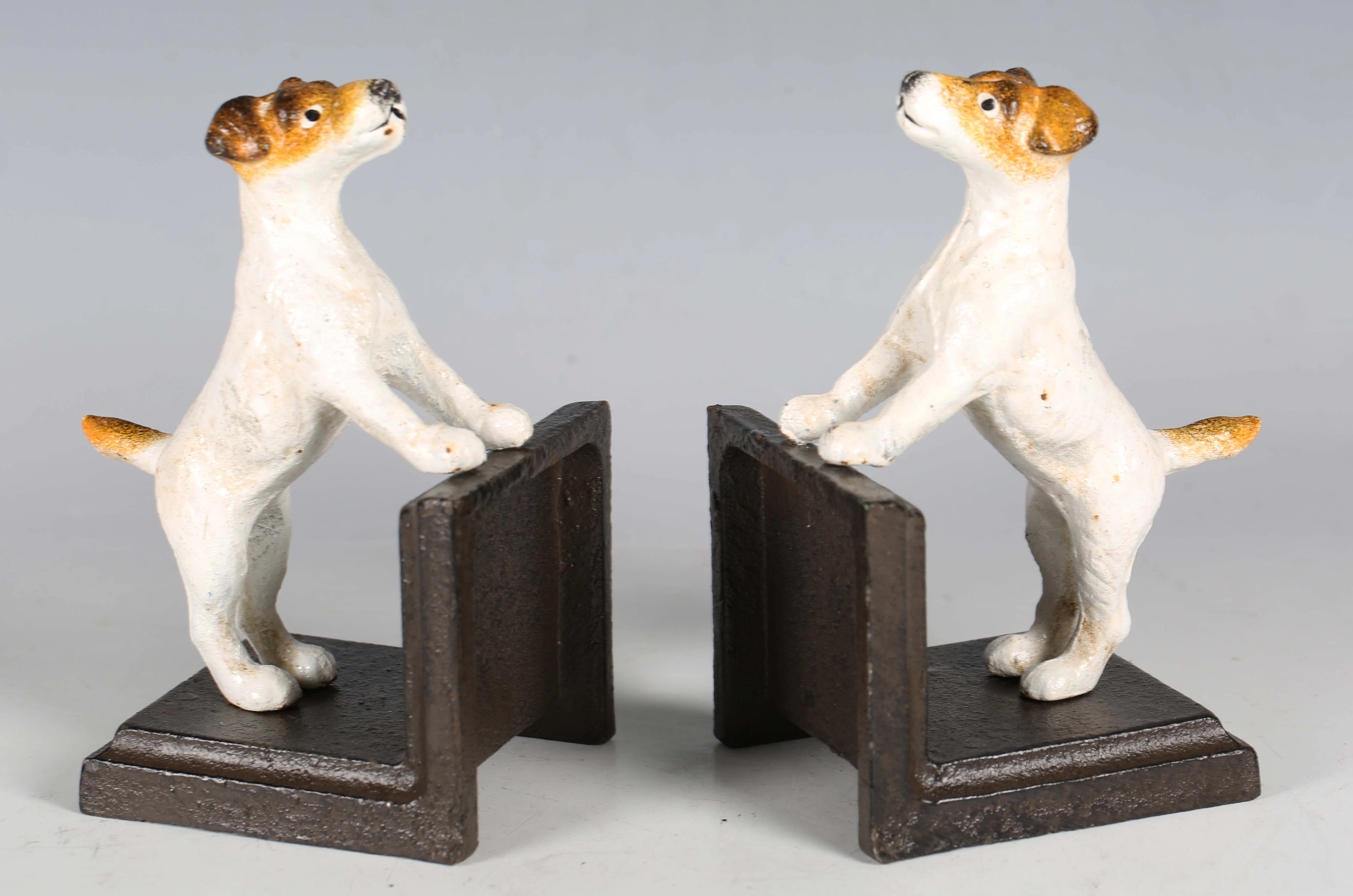 A pair of cold painted cast iron bookends, each with a Jack Russell