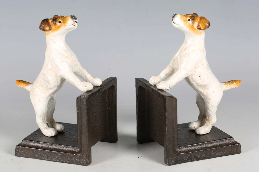 A pair of cold painted cast iron bookends, each with a Jack Russell