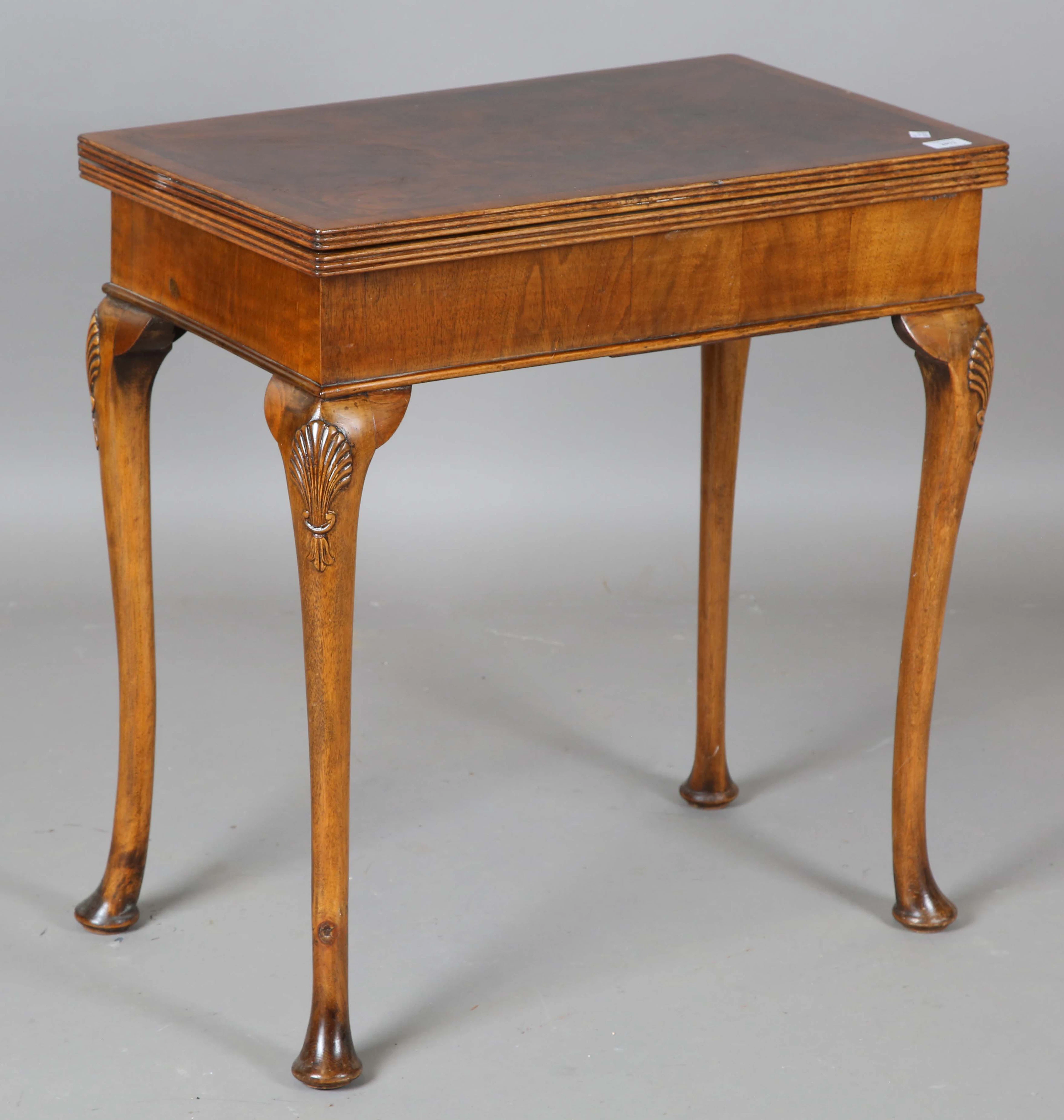 A mid-20th century Queen Anne style walnut fold-over card table, raised