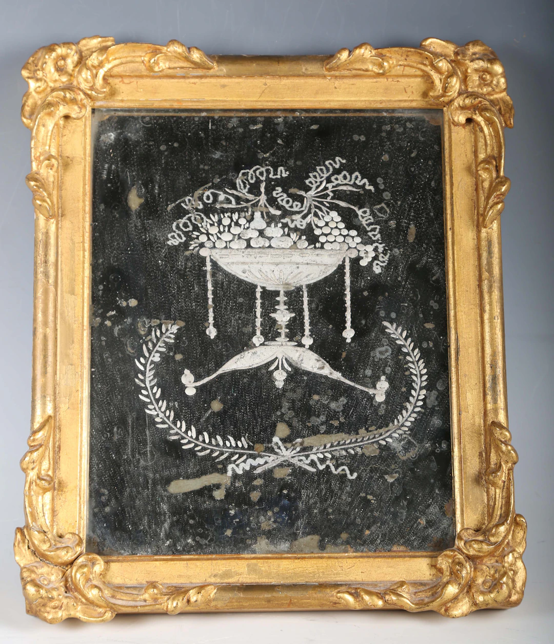 An 18th/19th century Venetian etched glass mirror, within a gilt composition